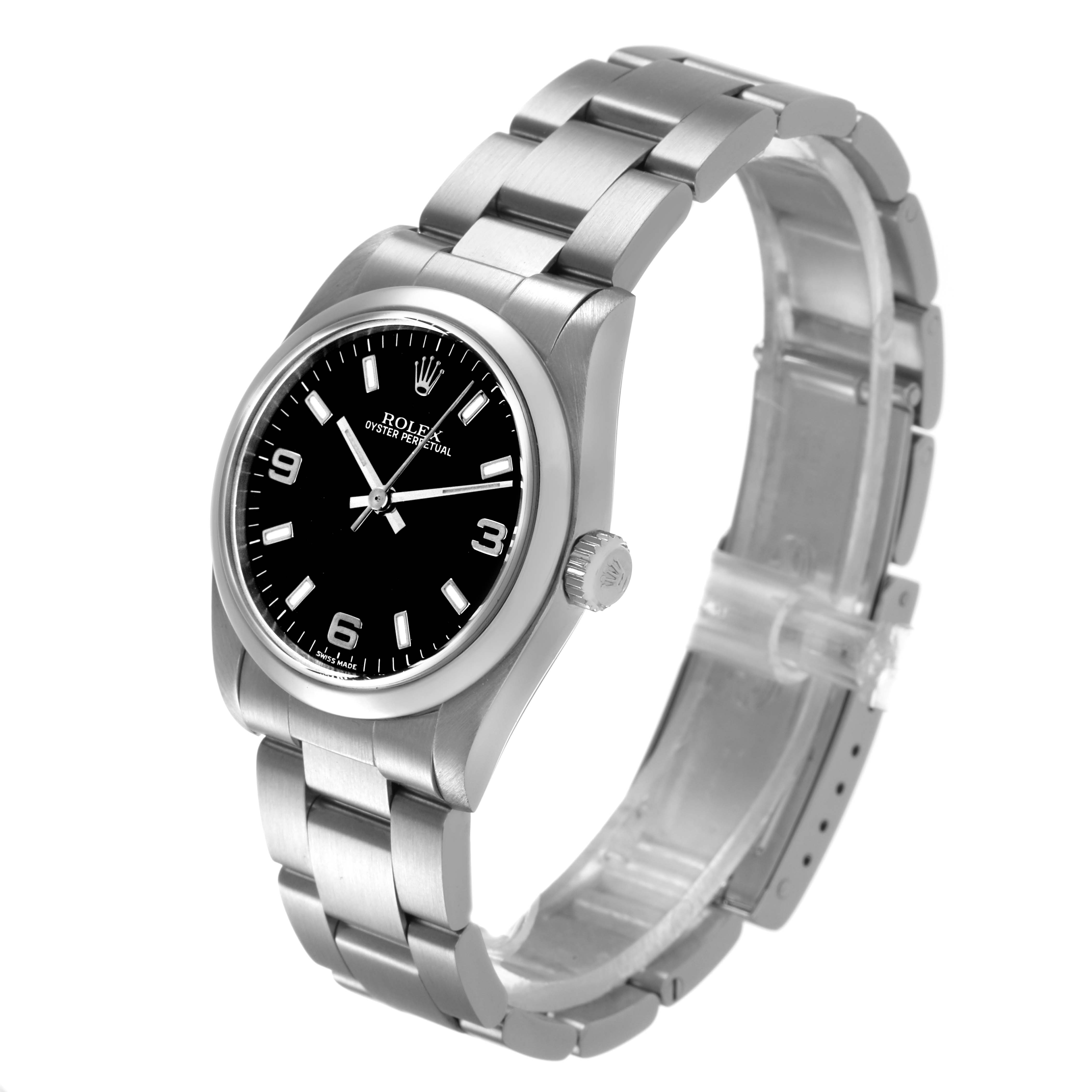 The Rolex Mid-Size 77080 Womens Stainless Steel Black Dial model is shown at an angled view, displaying the bracelet, case, bezel, crown, and black dial with markers.