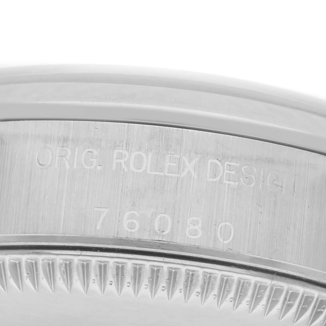 The image shows the side engraving on the bezel of a Rolex Oyster Perpetual 76080 Women
s Stainless Steel Pink Dial 76080 Women
s Stainless Steel Pink Dial, featuring the design and model number.