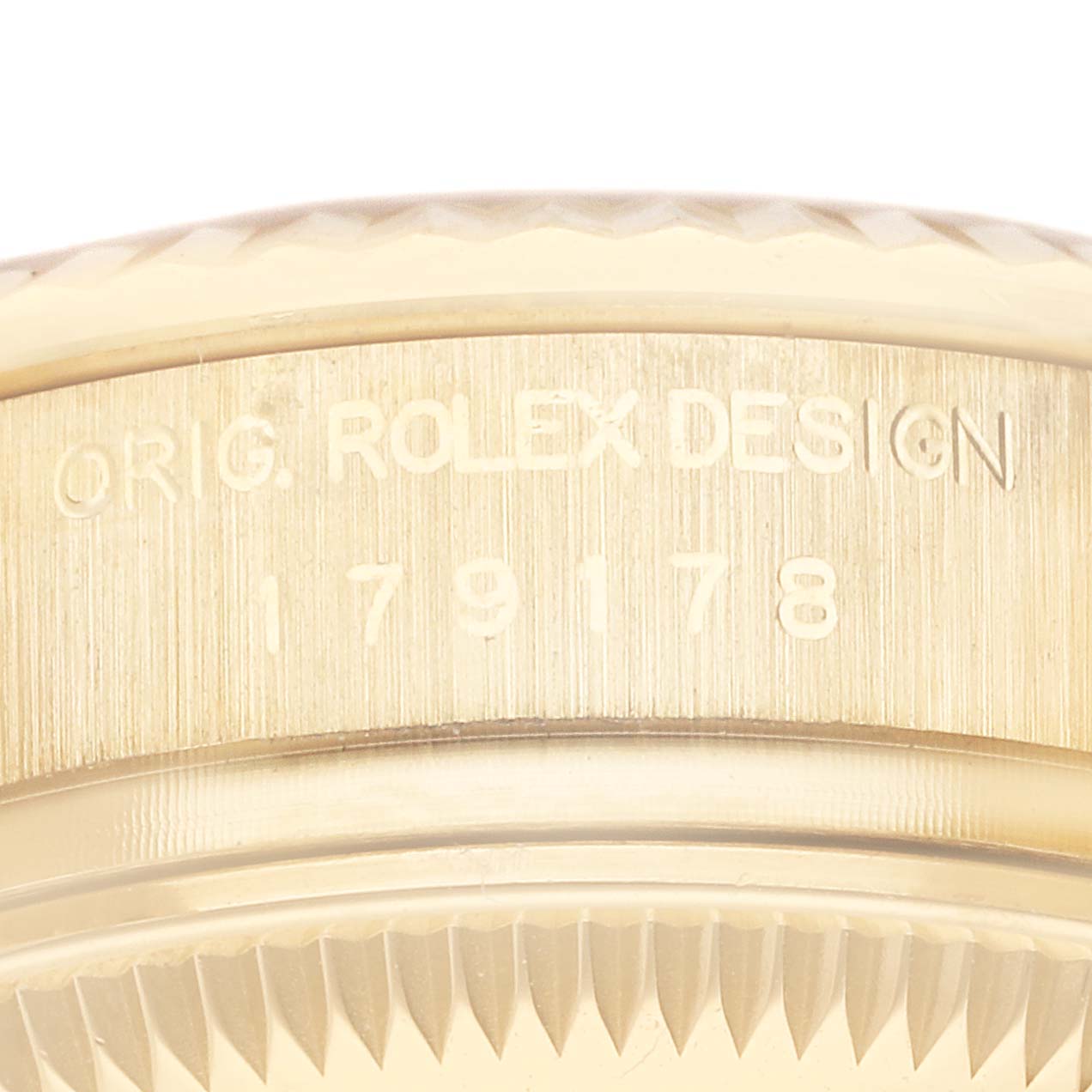 This close-up image shows the side engraving of a Rolex President 179178 Women's Yellow Gold Champagne Dial 179178 Women's Yellow Gold Champagne Dial model watch, displaying "ORIG. ROLEX DESIGN" and the model number.