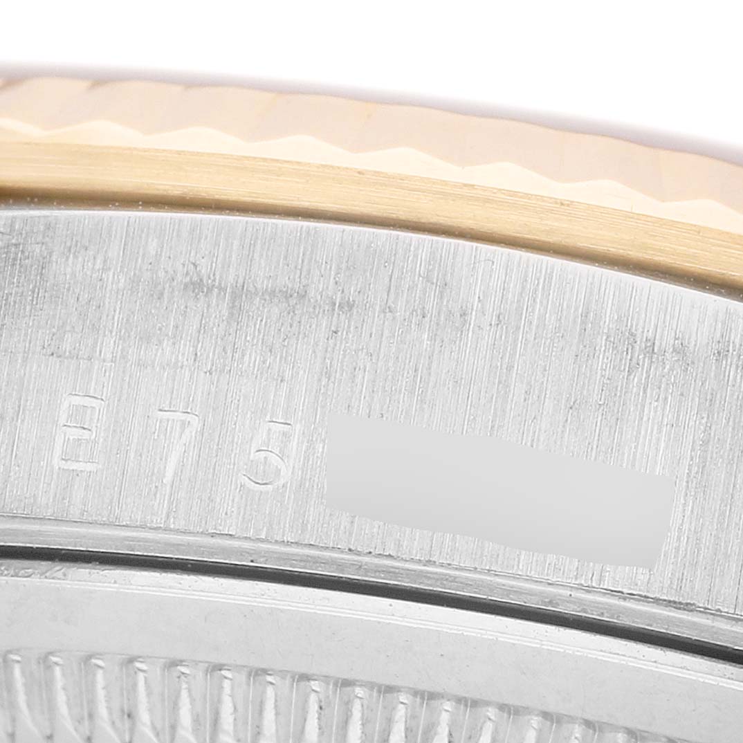 The image shows a close-up of the engraved edge on a Rolex President 18239BIC Men's White Gold Champagne Dial watch, highlighting the bezel and part of the case.