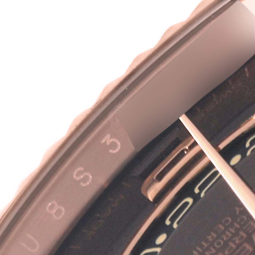 This close-up image of the Rolex Sky-Dweller 326135 Men's Rose Gold Brown Dial 326135 Men's Rose Gold Brown Dial watch shows the bezel and part of the dial.