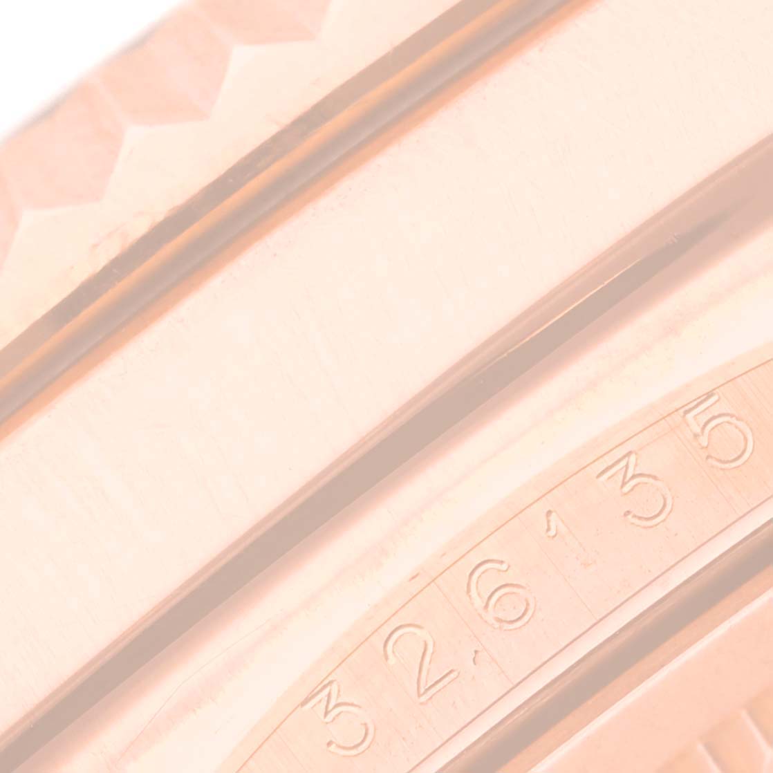 This is a close-up angle of the Rolex Sky-Dweller 326135 Men's Rose Gold Brown Dial 326135 Men's Rose Gold Brown Dial watch bezel and part of the case, showing the serial number.