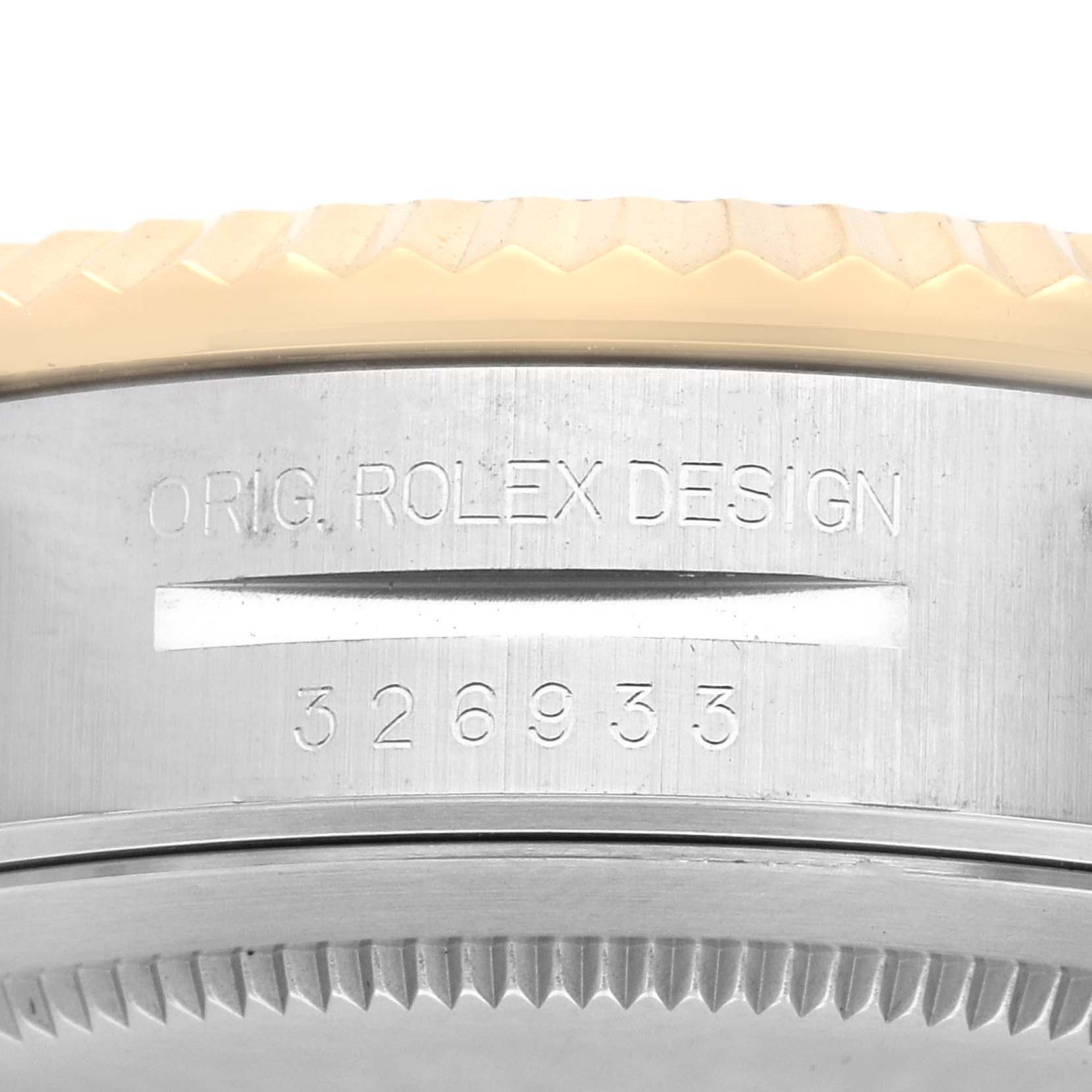 The image shows a close-up of the case side of a Rolex Sky-Dweller 326933 Men
s Steel and Gold (two tone) Silver Dial 326933 Men
s Steel and Gold (two tone) Silver Dial, focusing on the engraving and part of the bezel.