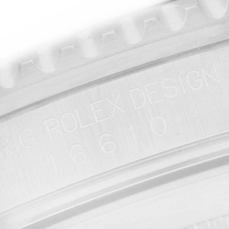 The image shows a close-up of the Rolex Submariner 16610 Men
s Stainless Steel Black Dial 16610 Men
s Stainless Steel Black Dial model
s engraved inner bezel with visible text.