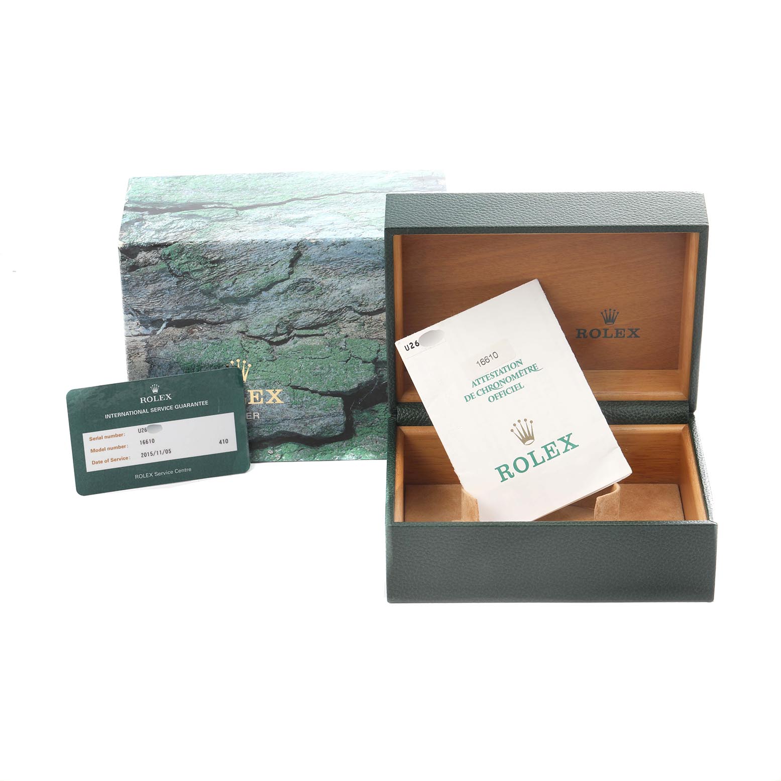 The image shows a Rolex Submariner 16610 Men
s Stainless Steel Black Dial 16610 Men
s Stainless Steel Black Dial watch box, an open green case, and related documents from a front angle.