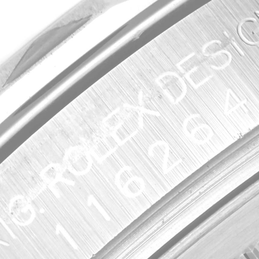 The image shows a close-up of the inner bezel and engraved serial number of a Rolex Turn-o-Graph 116264 Men's Stainless Steel White Dial 116264 Men's Stainless Steel White Dial watch.