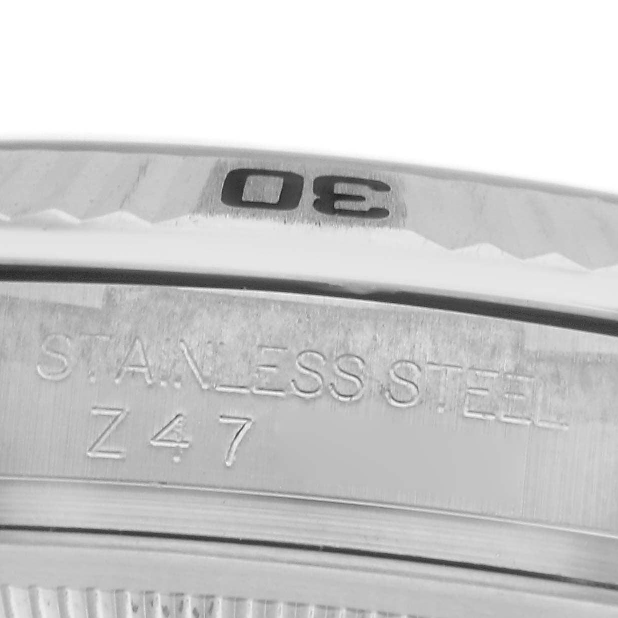 The image shows a close-up of the bezel and case side of a Rolex Turn-o-Graph 116264 Men
s Stainless Steel White Dial 116264 Men
s Stainless Steel White Dial watch, focusing on the engraved "STAINLESS STEEL" marking.