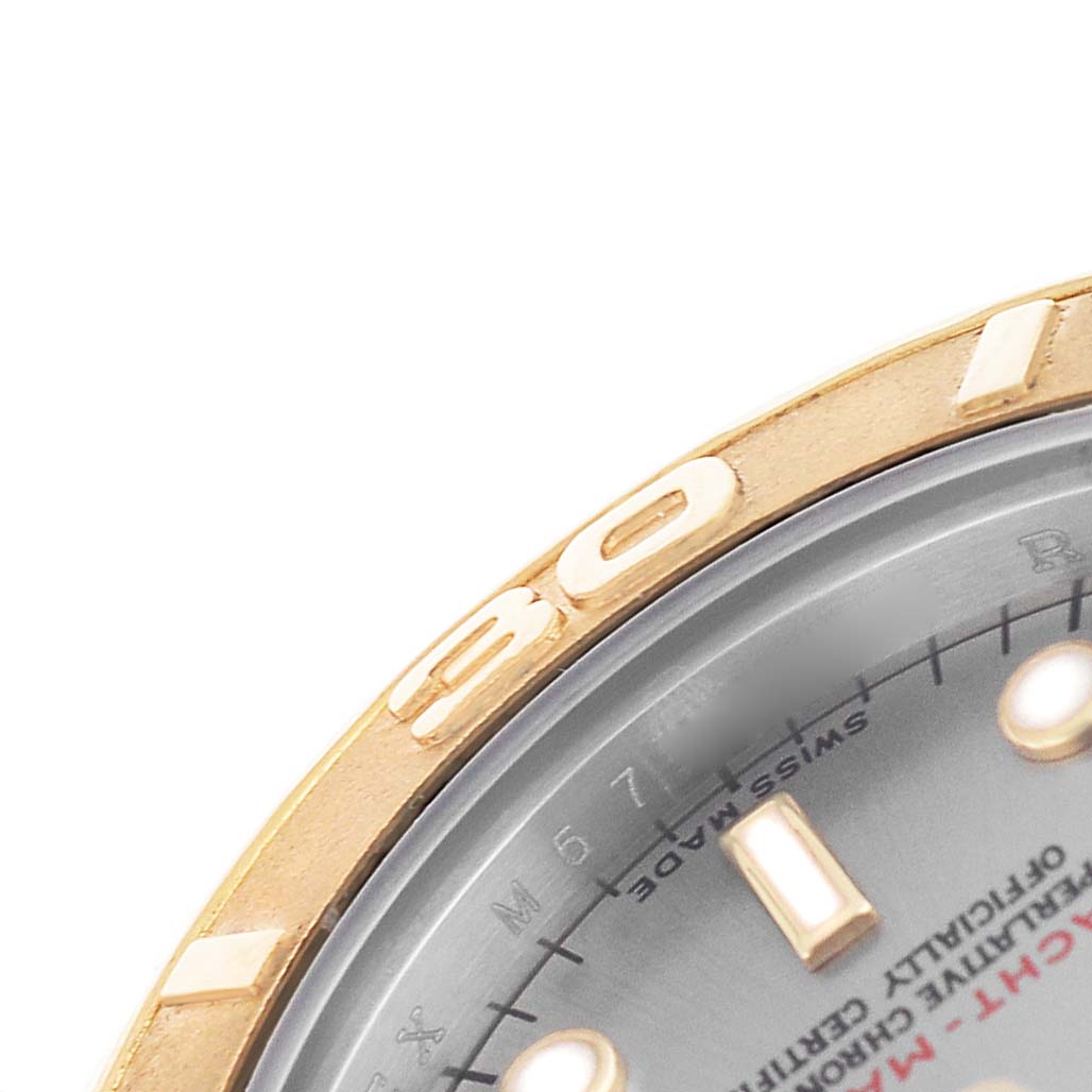 The image shows a close-up of the Rolex Yacht-Master 169623 Men's Steel and Gold (two tone) Green Dial bezel and part of the dial with indices and text.