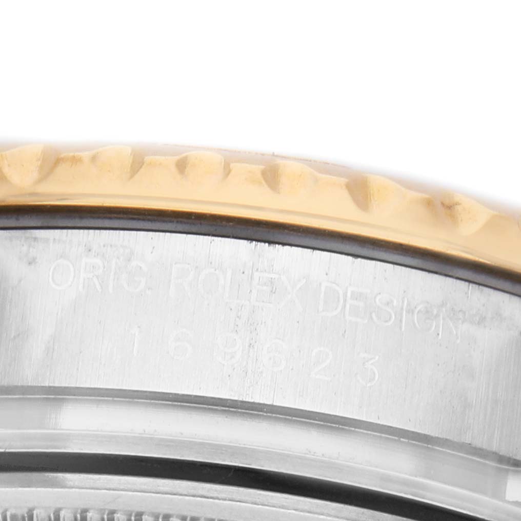 The image shows a close-up side view of the Rolex Yacht-Master 169623 Men's Steel and Gold (two tone) Green Dial model's gold bezel and engraved casing.