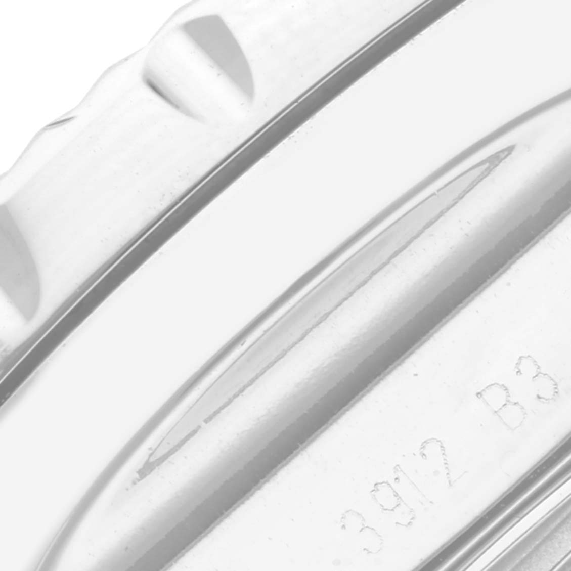 This image shows a close-up of the bezel and part of the case back of a Bentley model by Breitling.