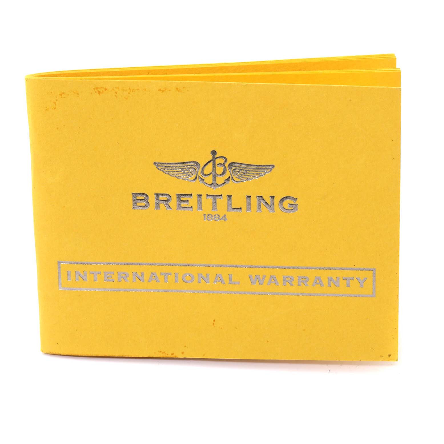 The image shows the yellow international warranty booklet for the Breitling Bentley A13362 Men's Stainless Steel Red Dial A13362 Men's Stainless Steel Red Dial model watch.