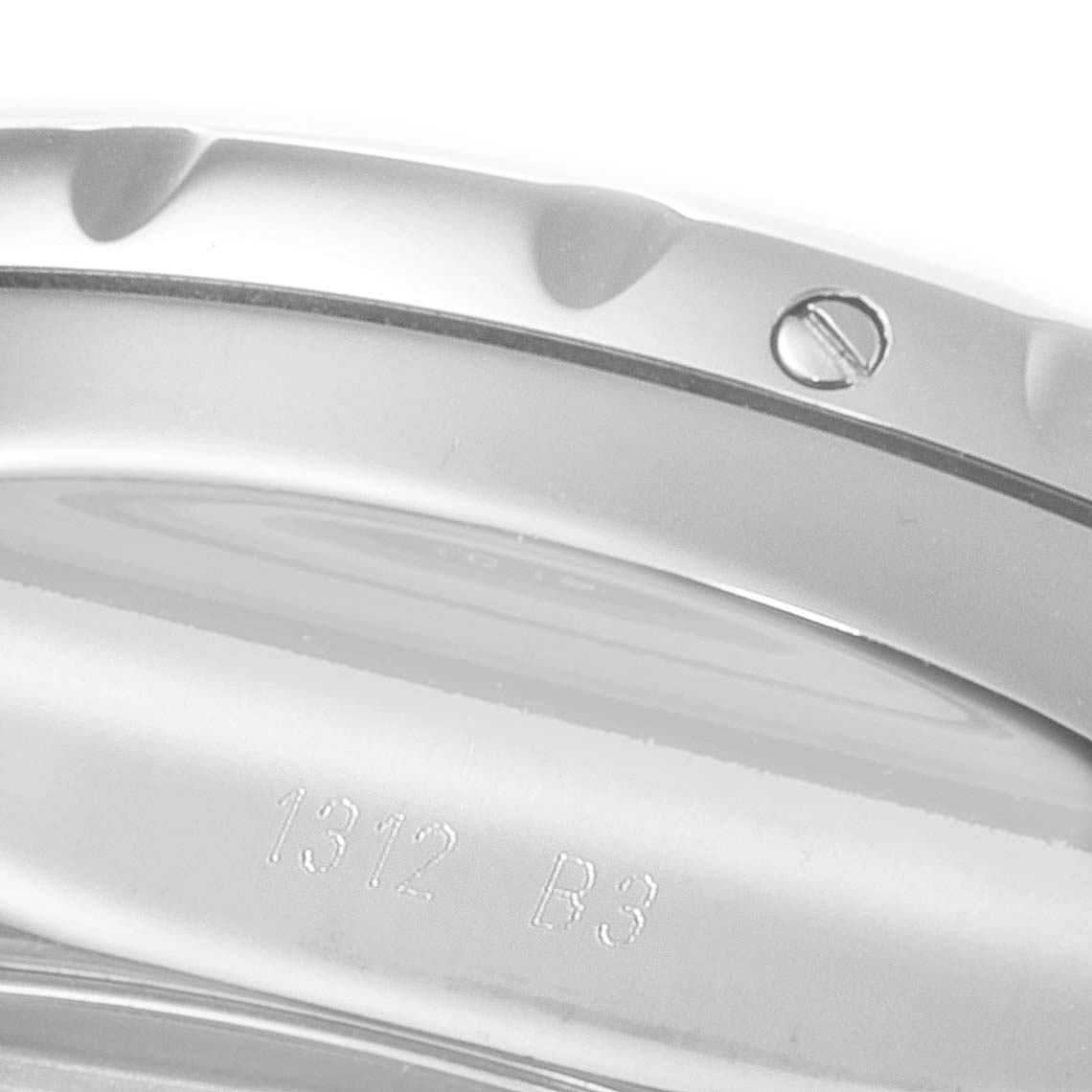 This image shows a close-up of the case and bezel of the Bentley model watch by Breitling, including a screw on the bezel and engraved numbers.