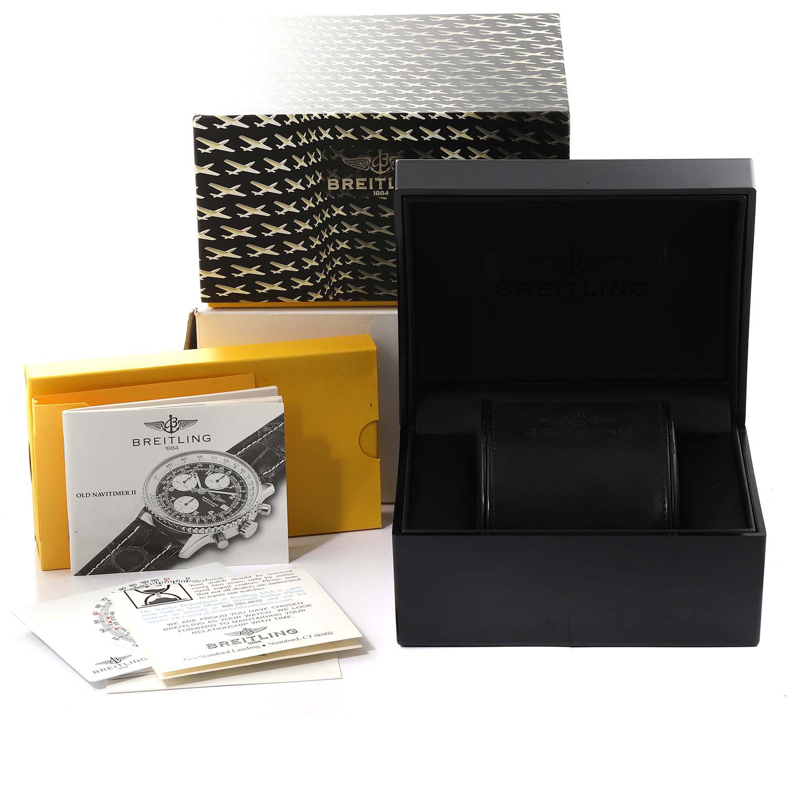 The image shows the packaging, user manual, and box for a Breitling Navitimer D13022 Men
s Stainless Steel White Dial D13022 Men
s Stainless Steel White Dial watch, viewed from the front.