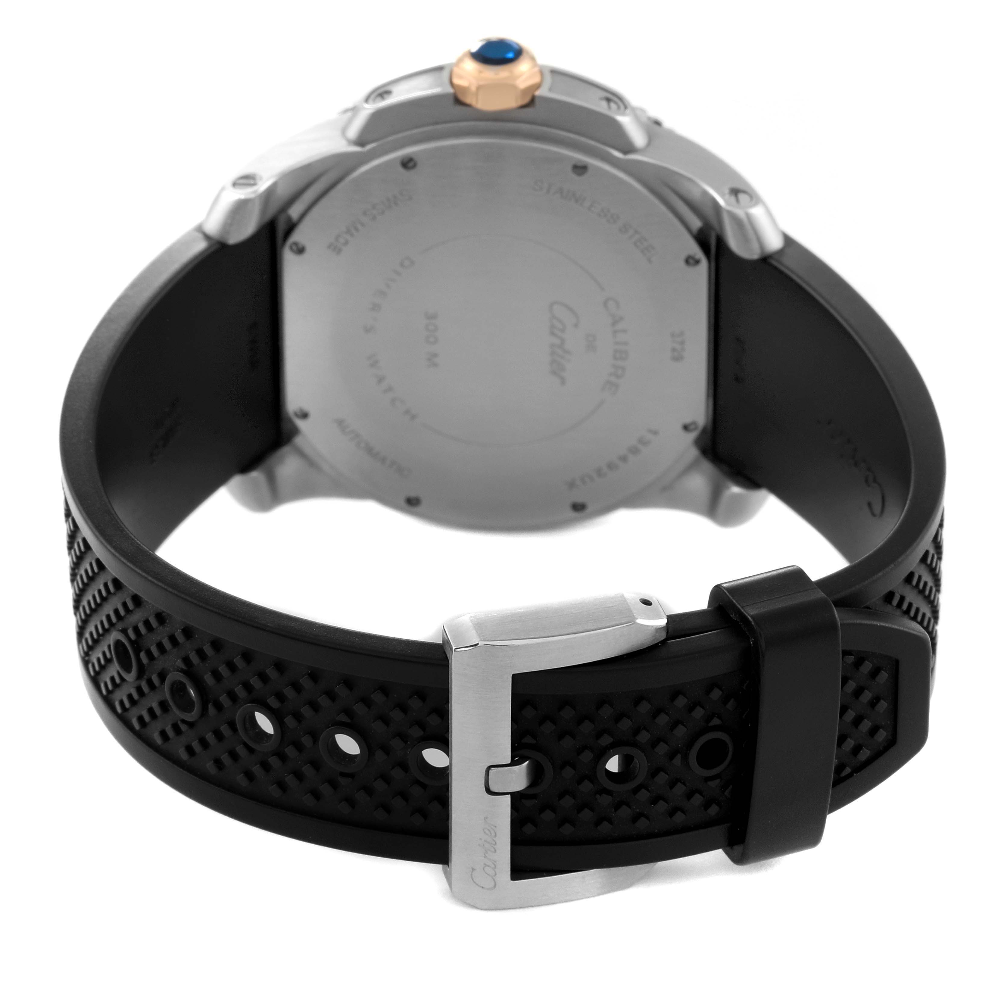 The image shows the back view of a Calibre de Cartier watch by Cartier, focusing on the case back and black strap with buckle.