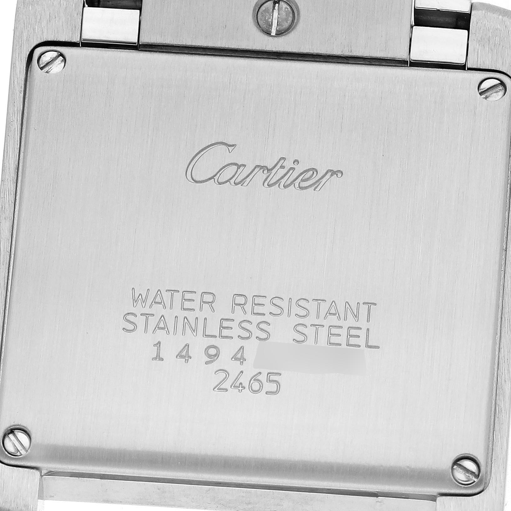 The image shows the back of a Cartier Tank Française watch, focusing on its stainless steel surface and engraved details.