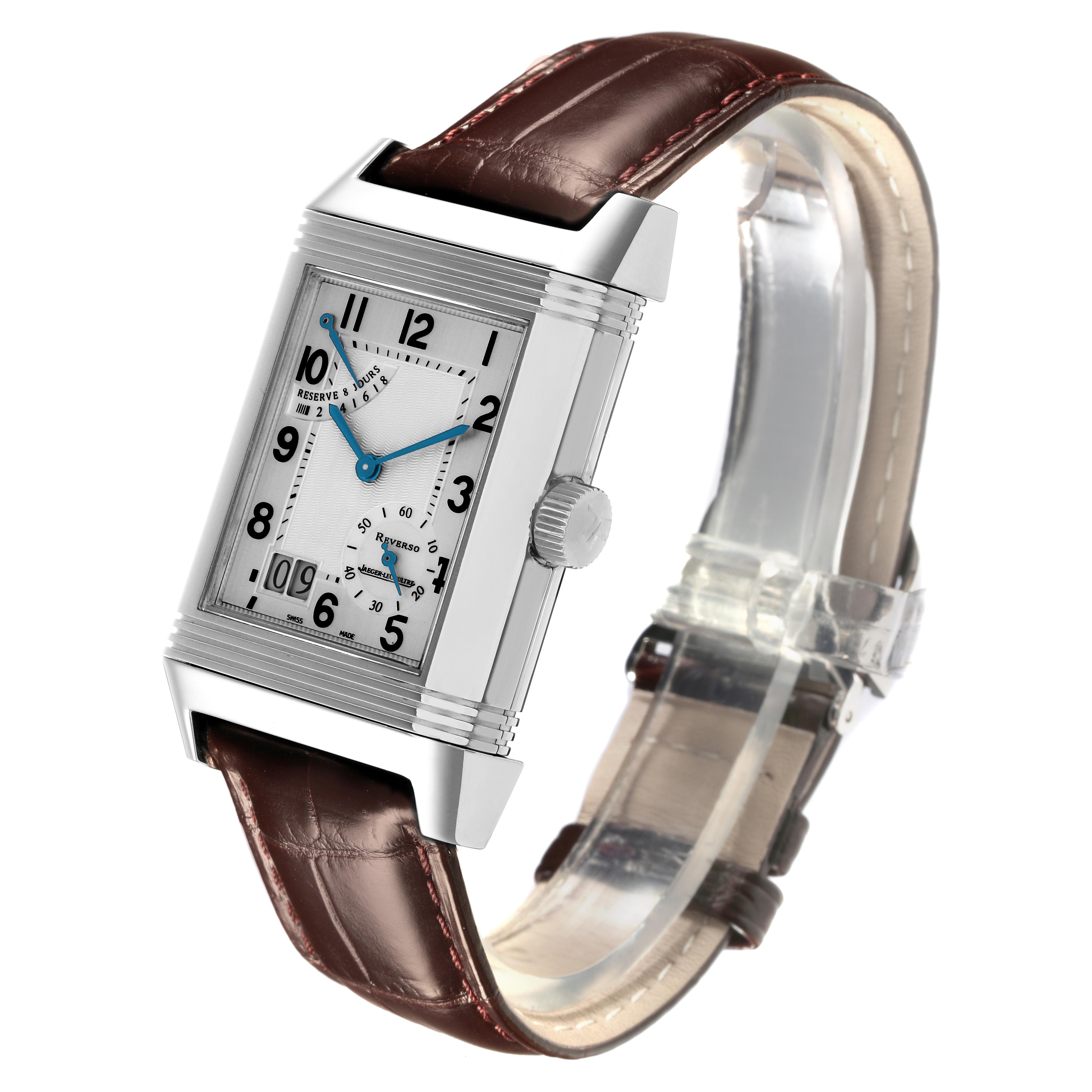 The Jaeger-LeCoultre Reverso watch is shown at an angle highlighting the front dial, crown, and leather strap.