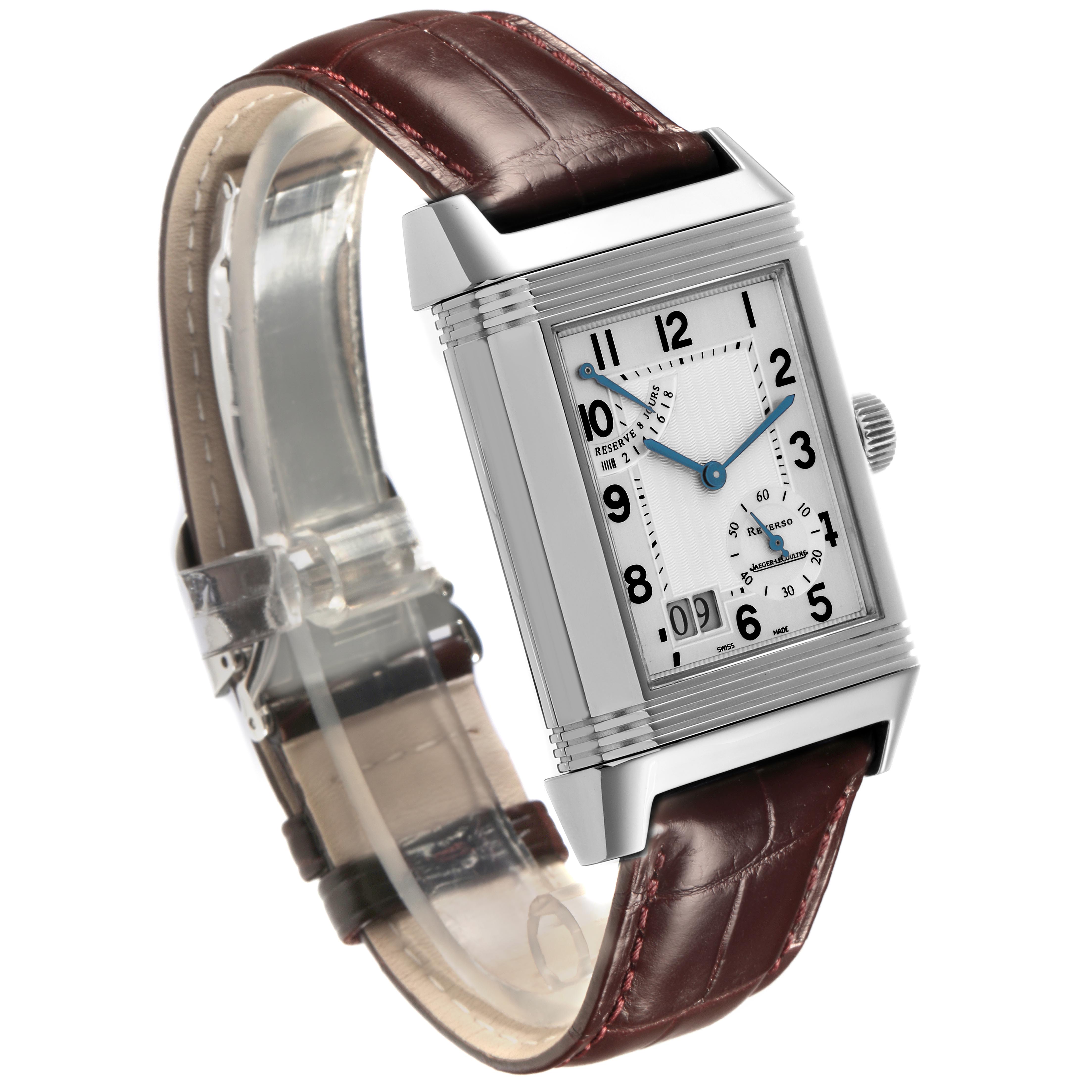 The Jaeger-LeCoultre Reverso watch is shown at a three-quarter angle, highlighting the rectangular dial and leather strap.