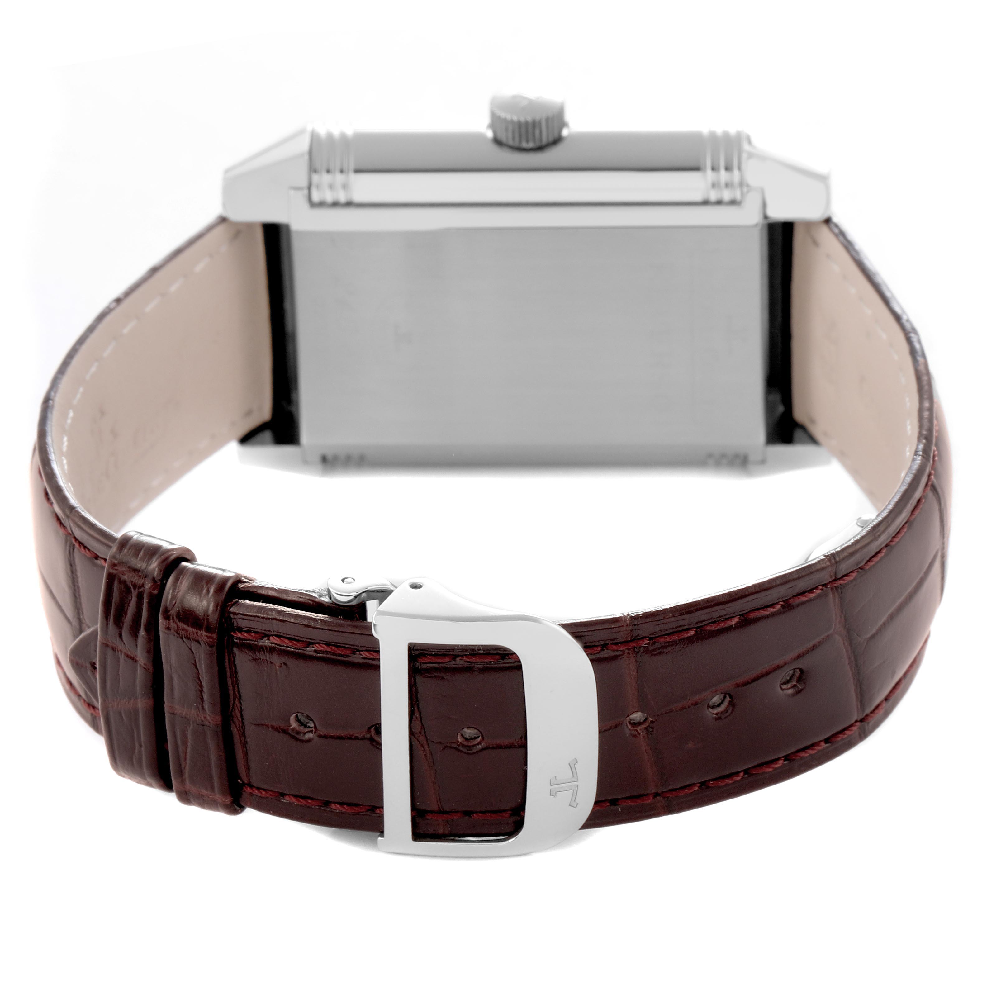 The Jaeger-LeCoultre Reverso watch is shown from the back with a focus on the strap and buckle.