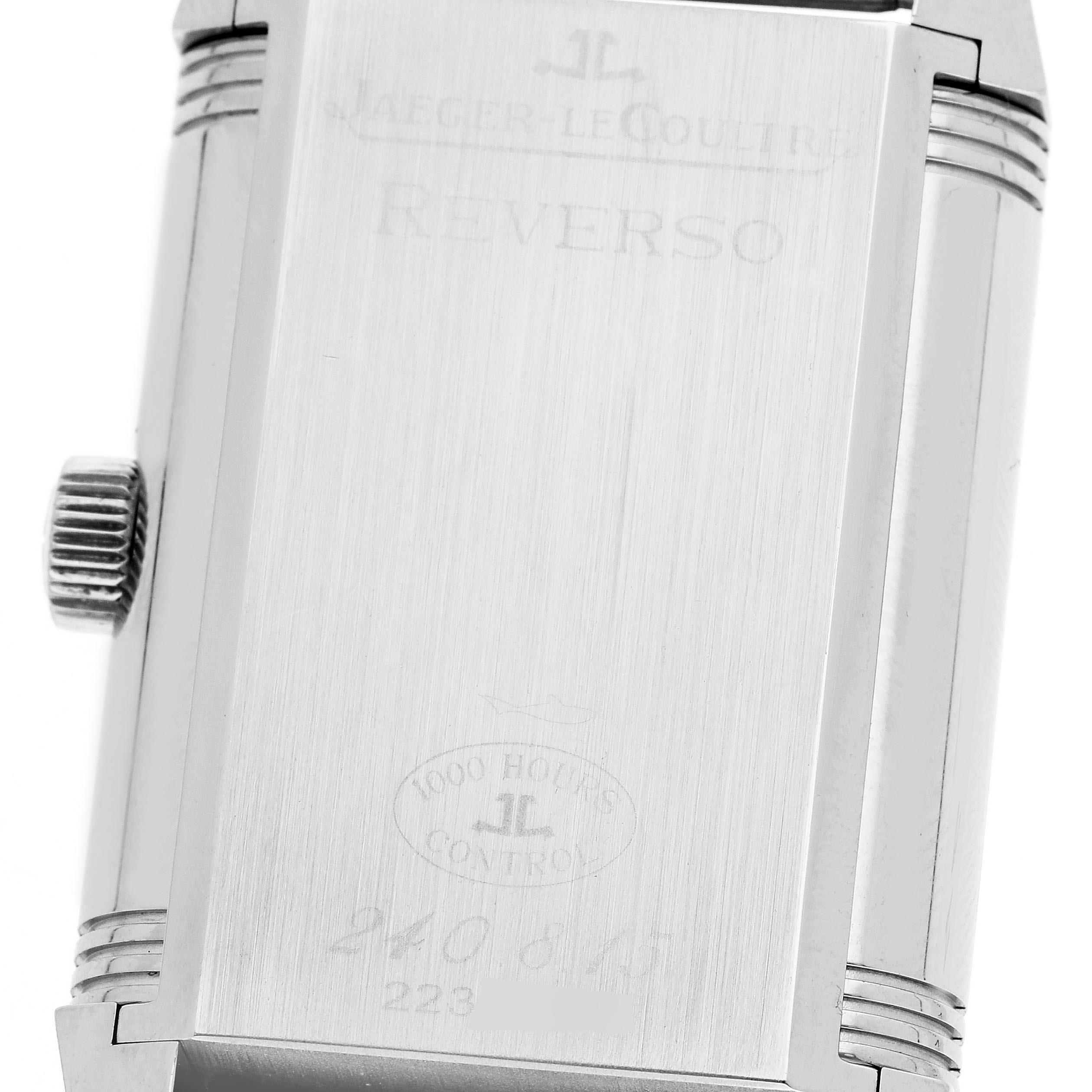 The image shows the back of the Jaeger-LeCoultre Reverso watch case and crown from a slightly tilted angle.