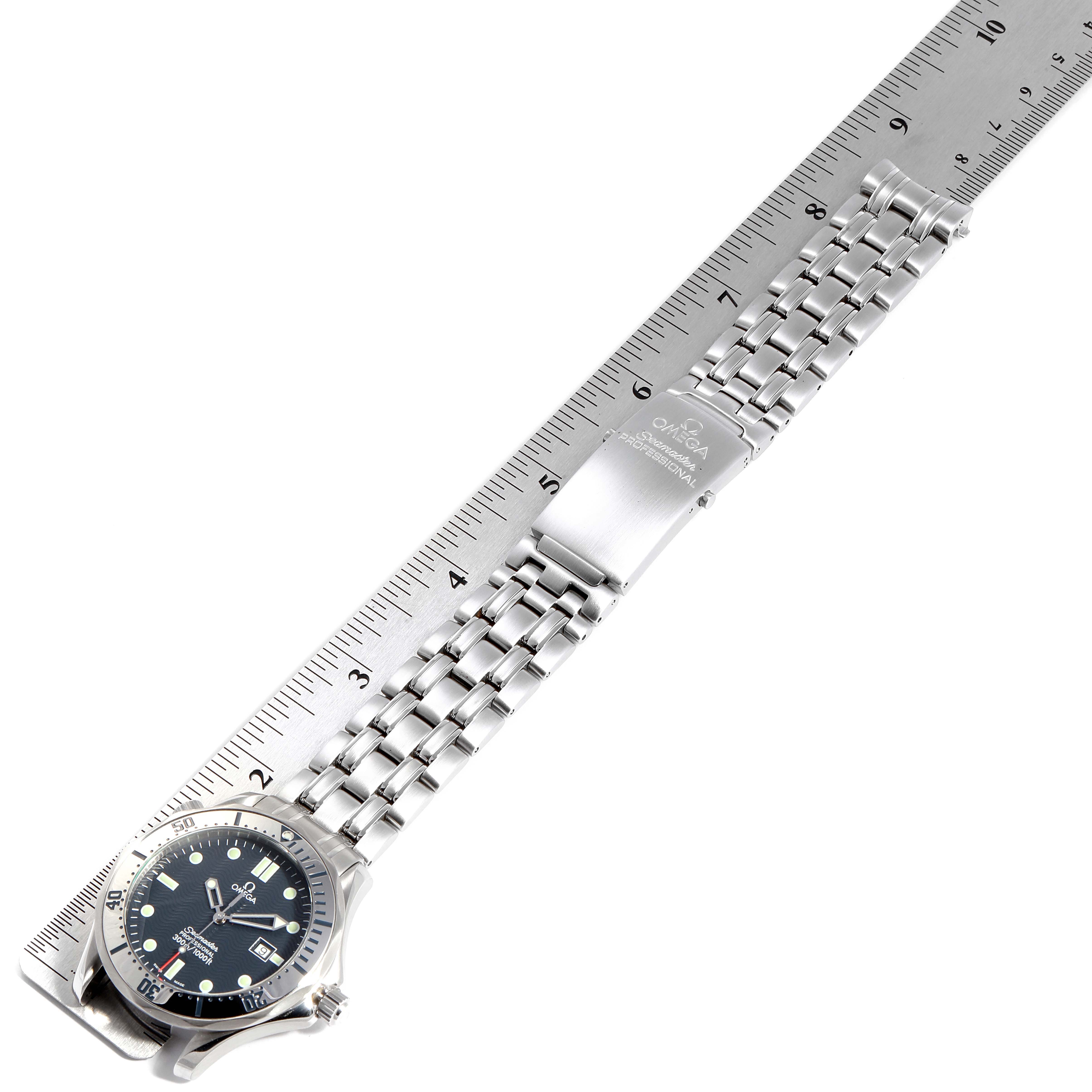 The image shows a full view of an Omega Seamaster 2542.80.00 Men
s Stainless Steel Blue Dial 2542.80.00 Men
s Stainless Steel Blue Dial watch placed against a ruler, showcasing the dial, bracelet, and clasp.