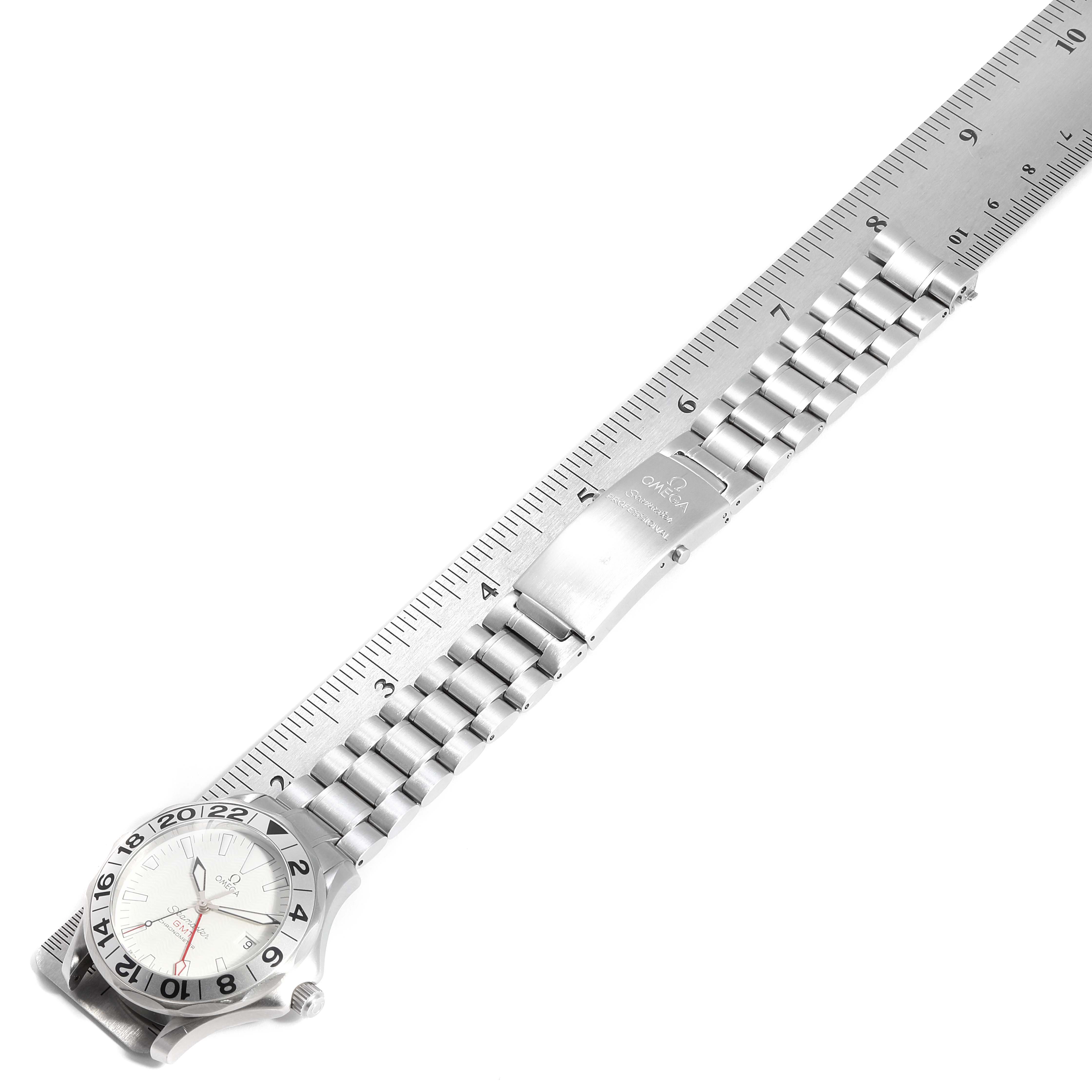 The image shows an Omega Seamaster 2538.20.00 Men's Stainless Steel White Dial 2538.20.00 Men's Stainless Steel White Dial watch laid flat against a ruler, displaying its bracelet and face from a top-down angle.
