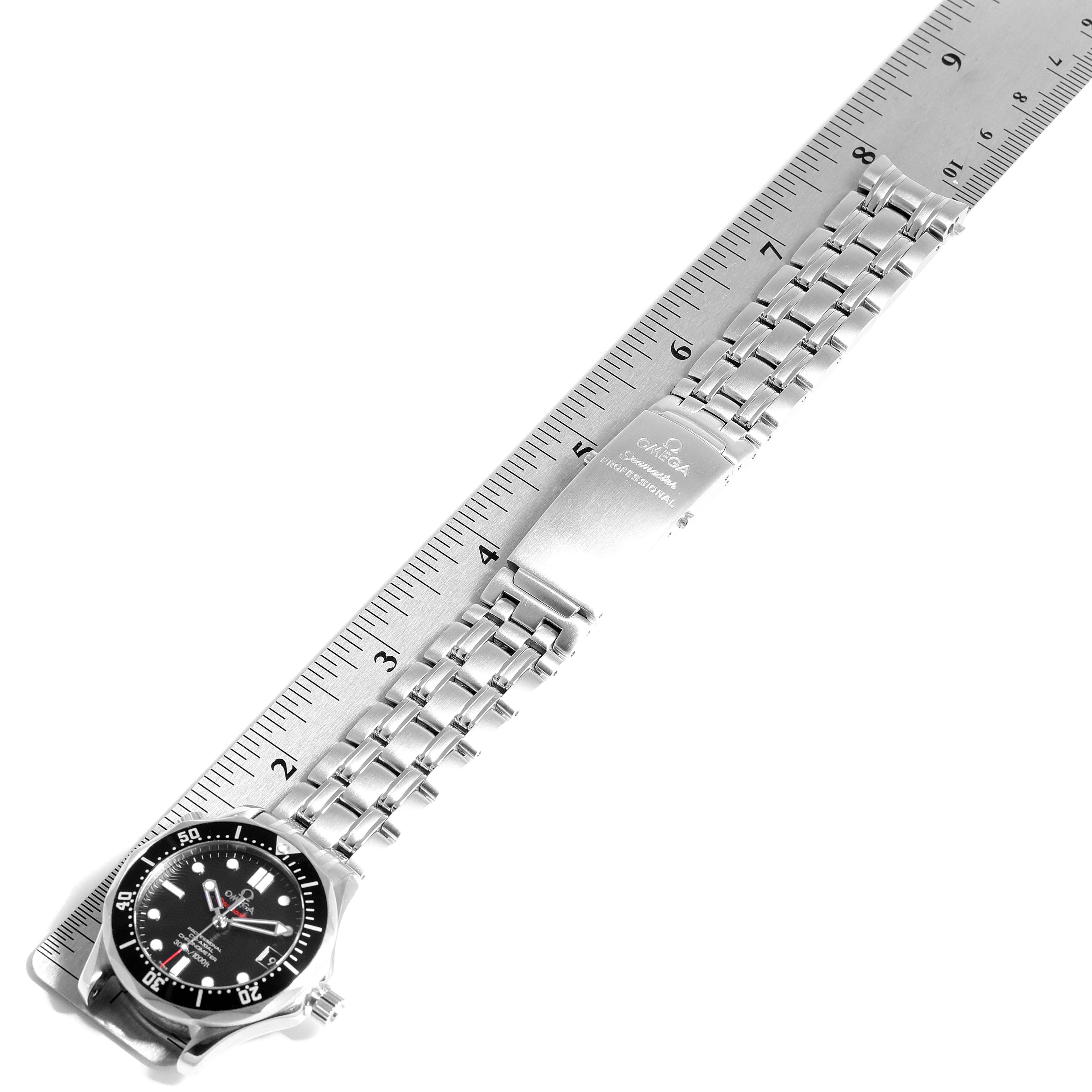 The image shows an Omega Seamaster 212.30.36.20.01.001 Men
s Stainless Steel Black Dial 212.30.36.20.01.001 Men
s Stainless Steel Black Dial watch laid flat next to a ruler, highlighting its bezel, dial, bracelet, and clasp.