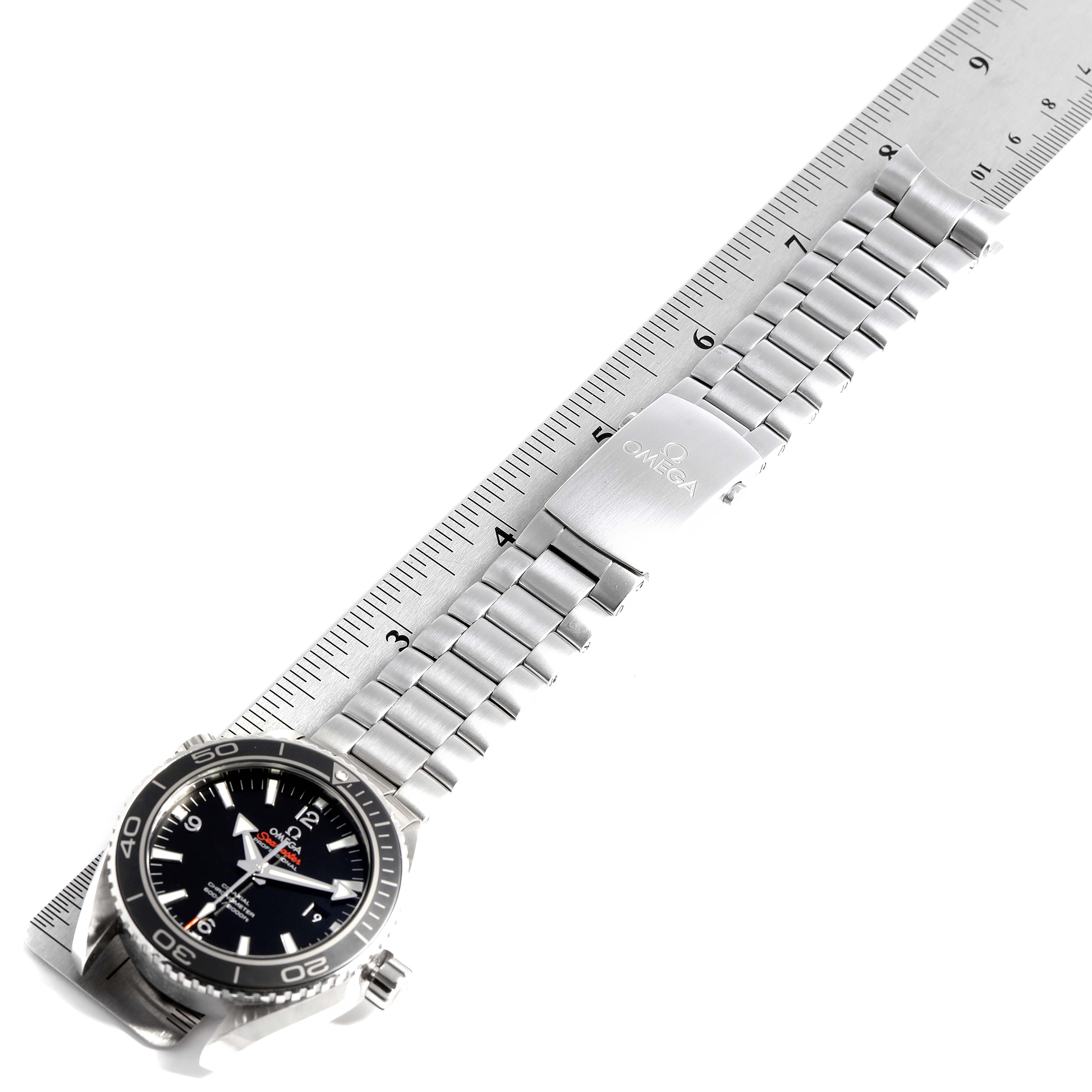 The image shows the front of the Omega Planet Ocean 232.30.46.21.01.001 Men
s Stainless Steel Black Dial 232.30.46.21.01.001 Men
s Stainless Steel Black Dial watch, highlighting its face, bezel, and metal bracelet against a ruler.