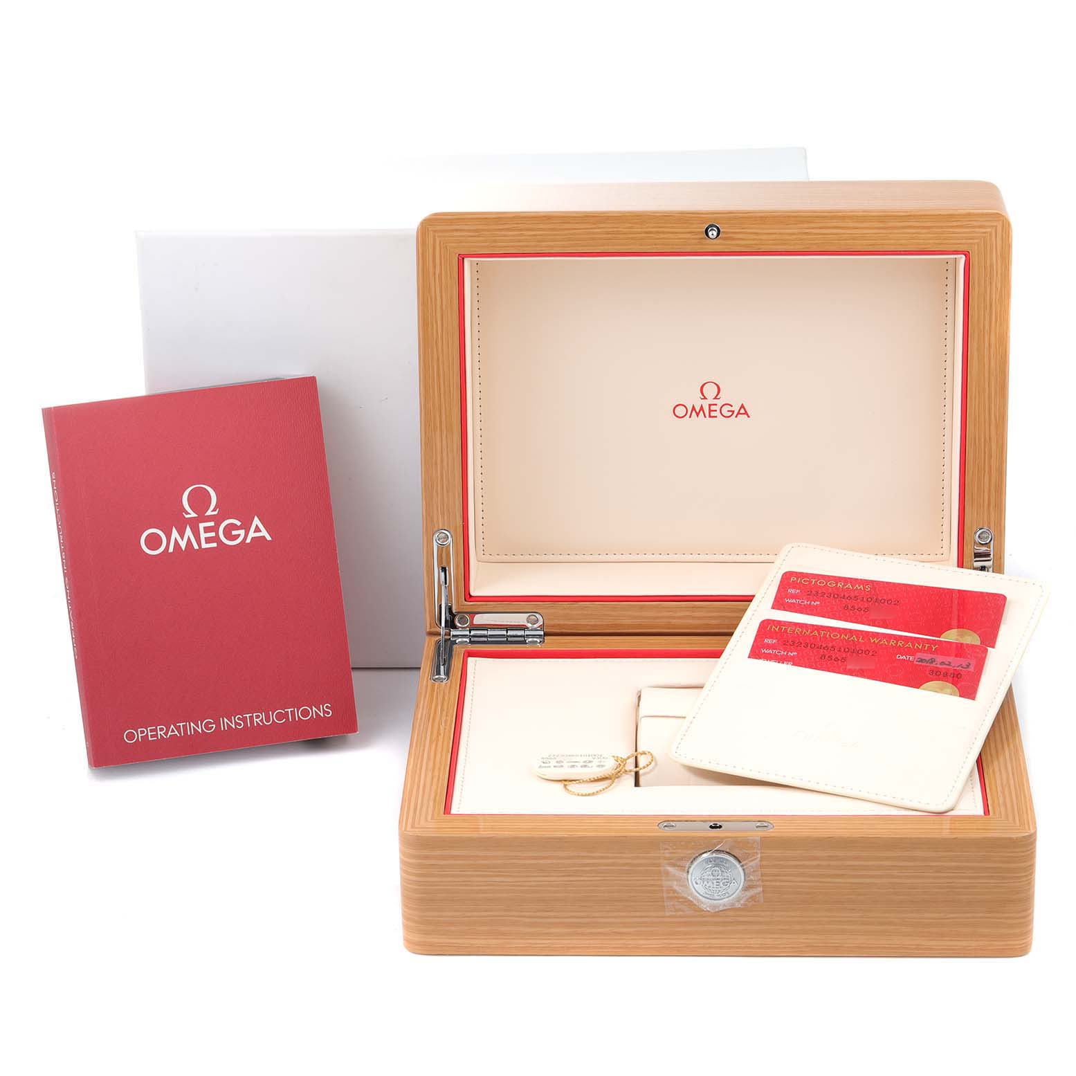 The image shows the Omega Planet Ocean 232.30.46.51.01.002 Men
s Stainless Steel Black Dial 232.30.46.51.01.002 Men
s Stainless Steel Black Dial watch accessories, including a wooden box, operating instructions, and warranty cards.