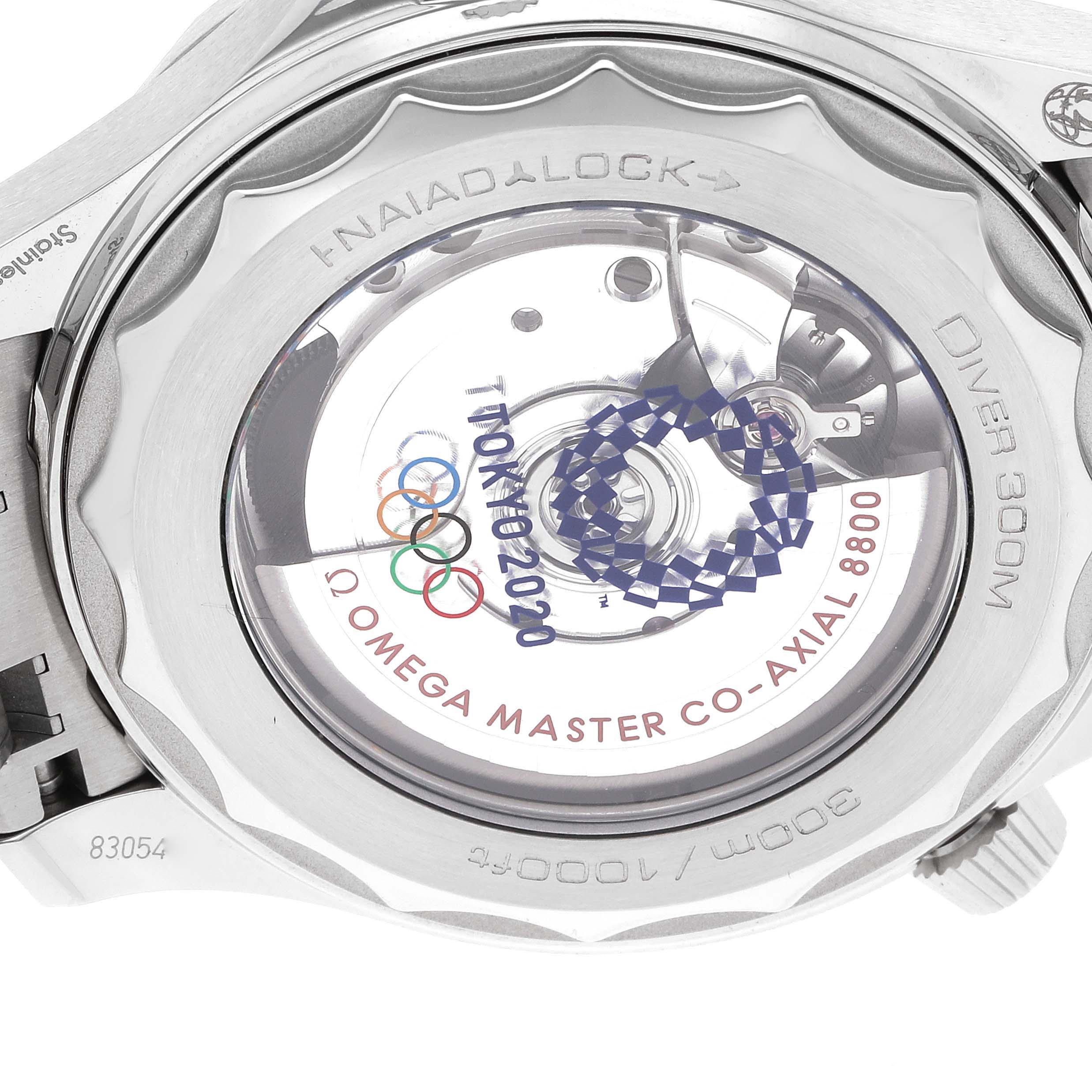 The image shows the case back of the Omega Seamaster 522.30.42.20.04.001 Men's Stainless Steel White Dial 522.30.42.20.04.001 Men's Stainless Steel White Dial Diver 300M, revealing the movement and marking for Tokyo 2020.