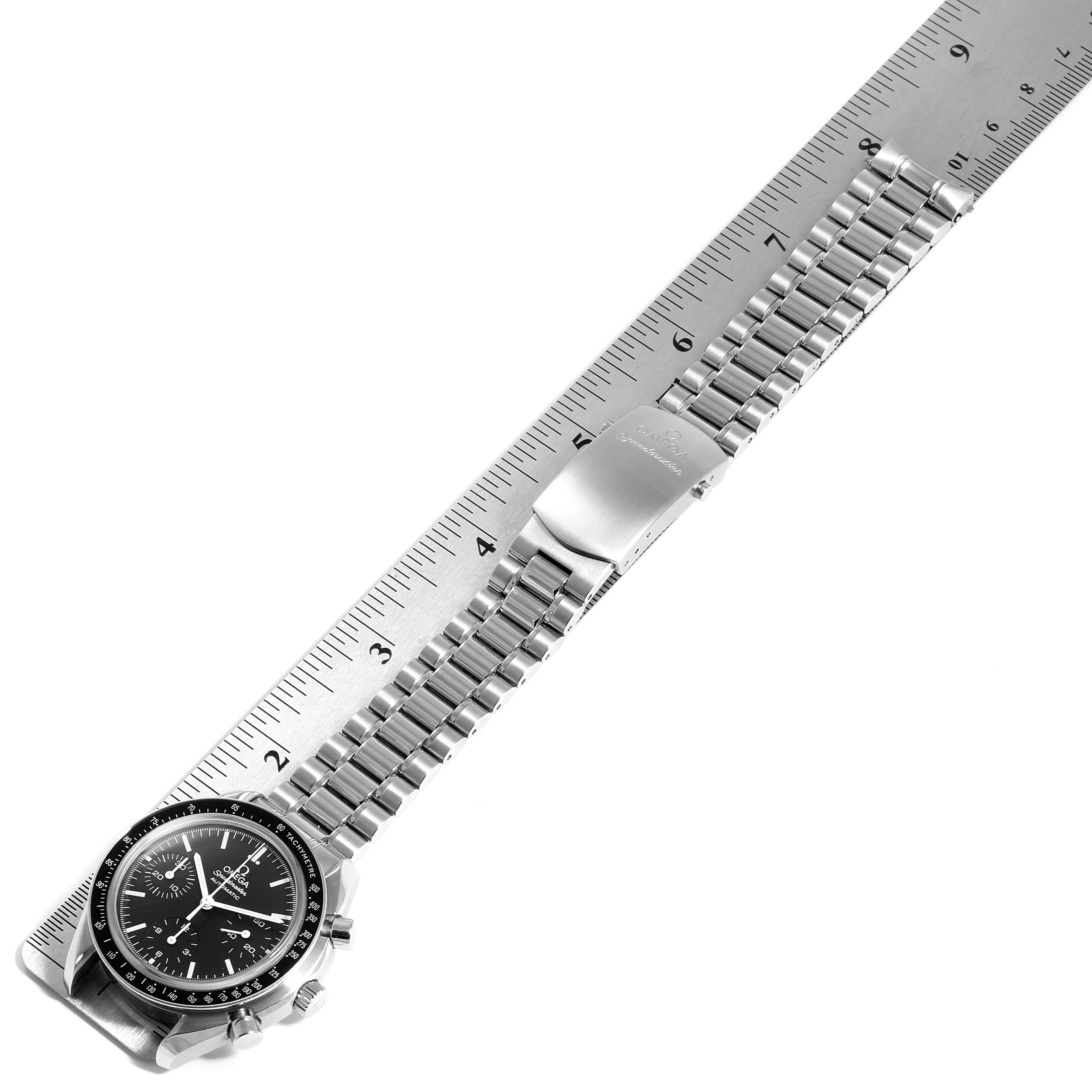 The image shows a top-down view of an Omega Speedmaster 3539.50.00 Men
s Stainless Steel Black Dial 3539.50.00 Men
s Stainless Steel Black Dial watch with a metal bracelet and clasp, measured against a ruler.