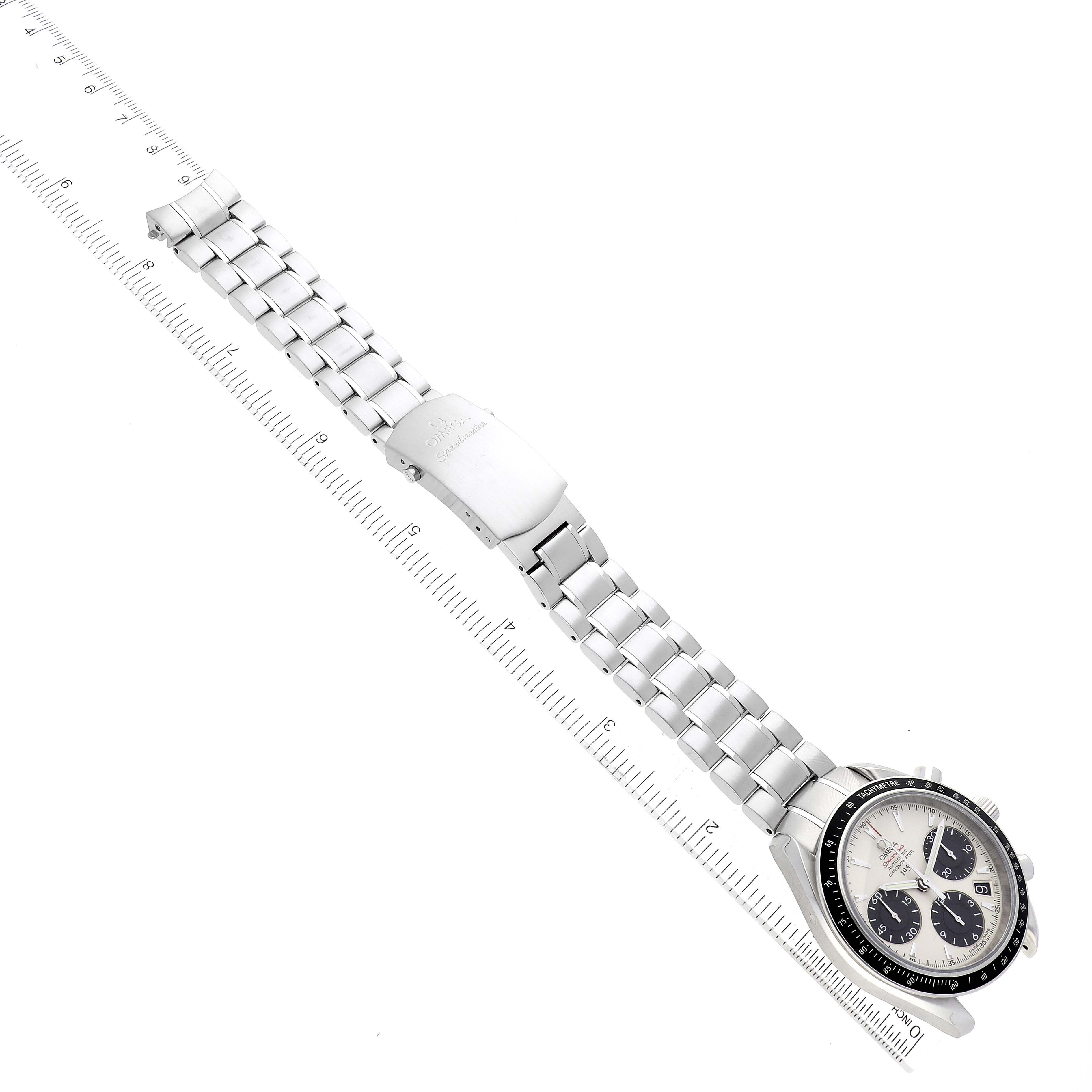 The Omega Speedmaster 323.30.40.40.02.001 Men
s Stainless Steel White Dial 323.30.40.40.02.001 Men
s Stainless Steel White Dial watch is shown at an angle displaying its full length, metal bracelet, clasp, and face with a ruler for scale.