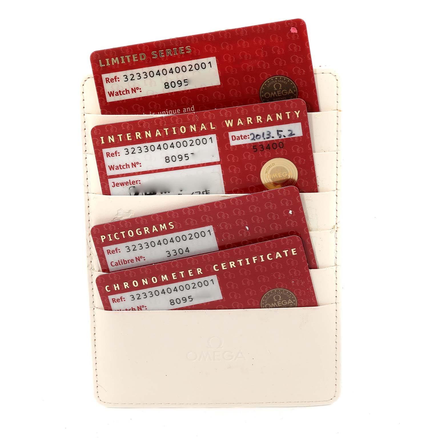 The image shows Omega Speedmaster 323.30.40.40.02.001 Men
s Stainless Steel White Dial 323.30.40.40.02.001 Men
s Stainless Steel White Dial warranty and certification cards in a white Omega cardholder, viewed from the front.