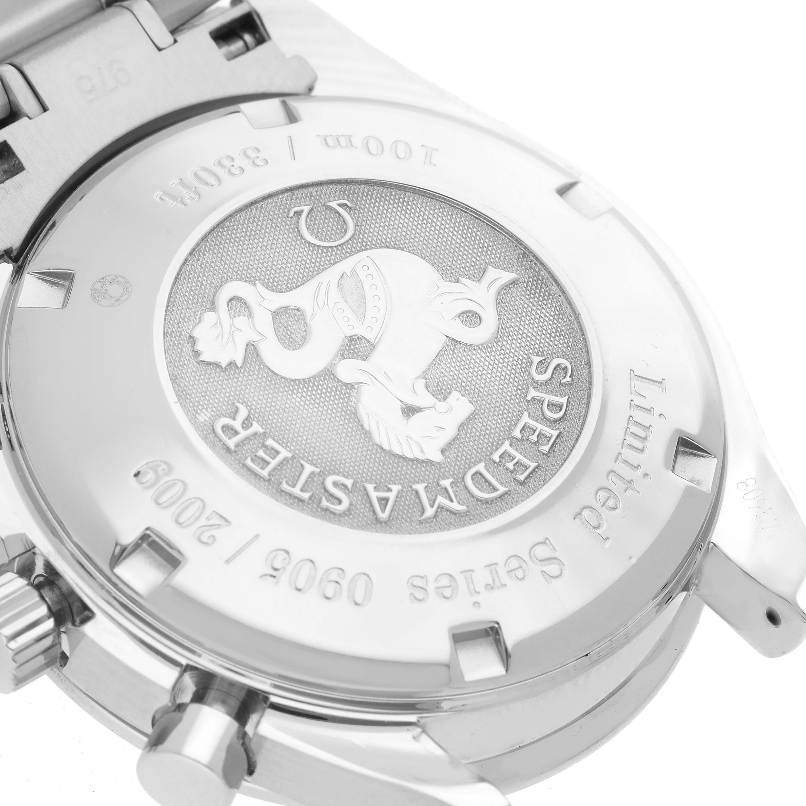 The image shows the case back of an Omega Speedmaster 323.30.40.40.02.001 Men
s Stainless Steel White Dial 323.30.40.40.02.001 Men
s Stainless Steel White Dial watch at an angle, highlighting its engraved details and metal bracelet attachment.