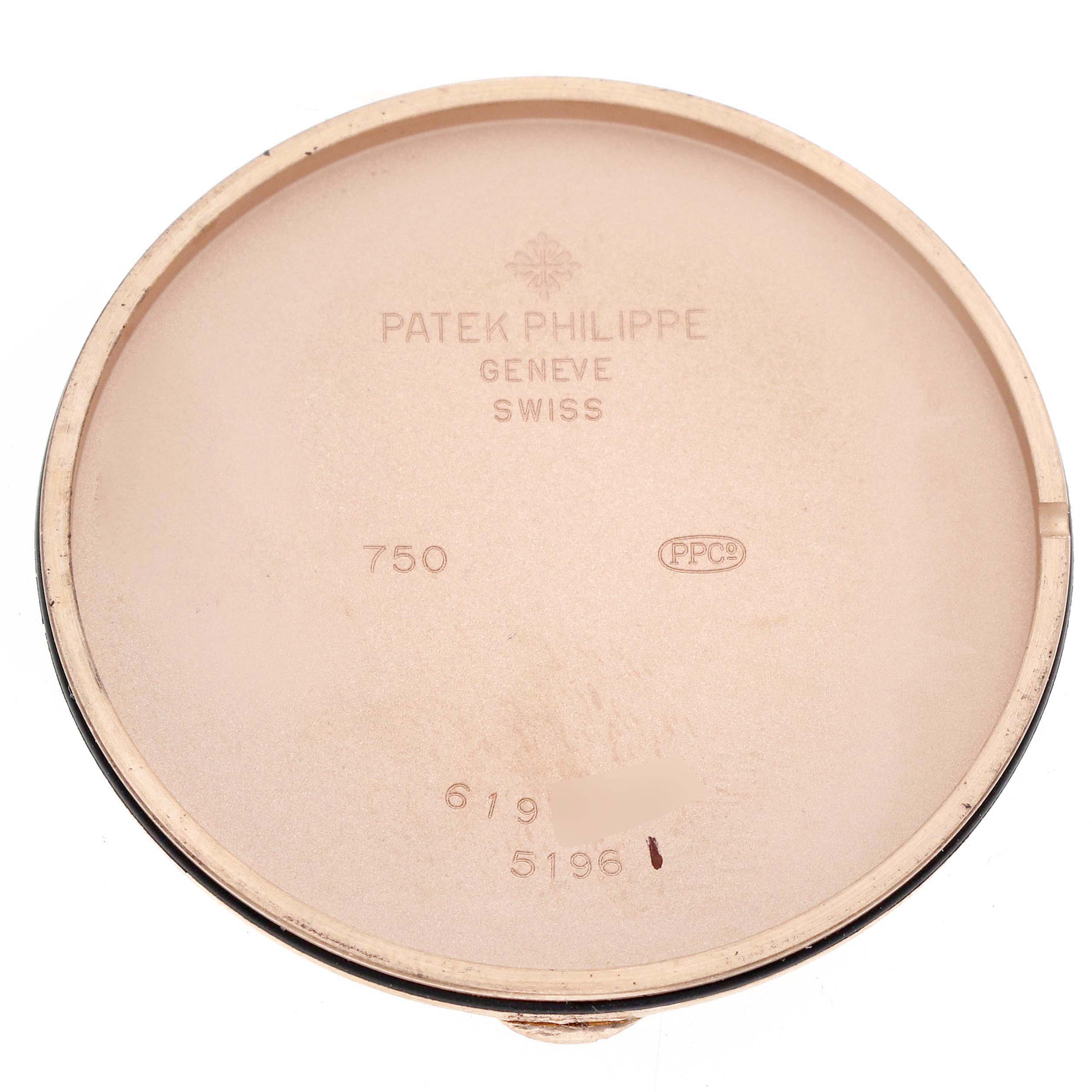 The image shows the inside of a Patek Philippe Calatrava 5196R-001 Men's Rose Gold Silver Dial watch case back, revealing inscriptions and branding.