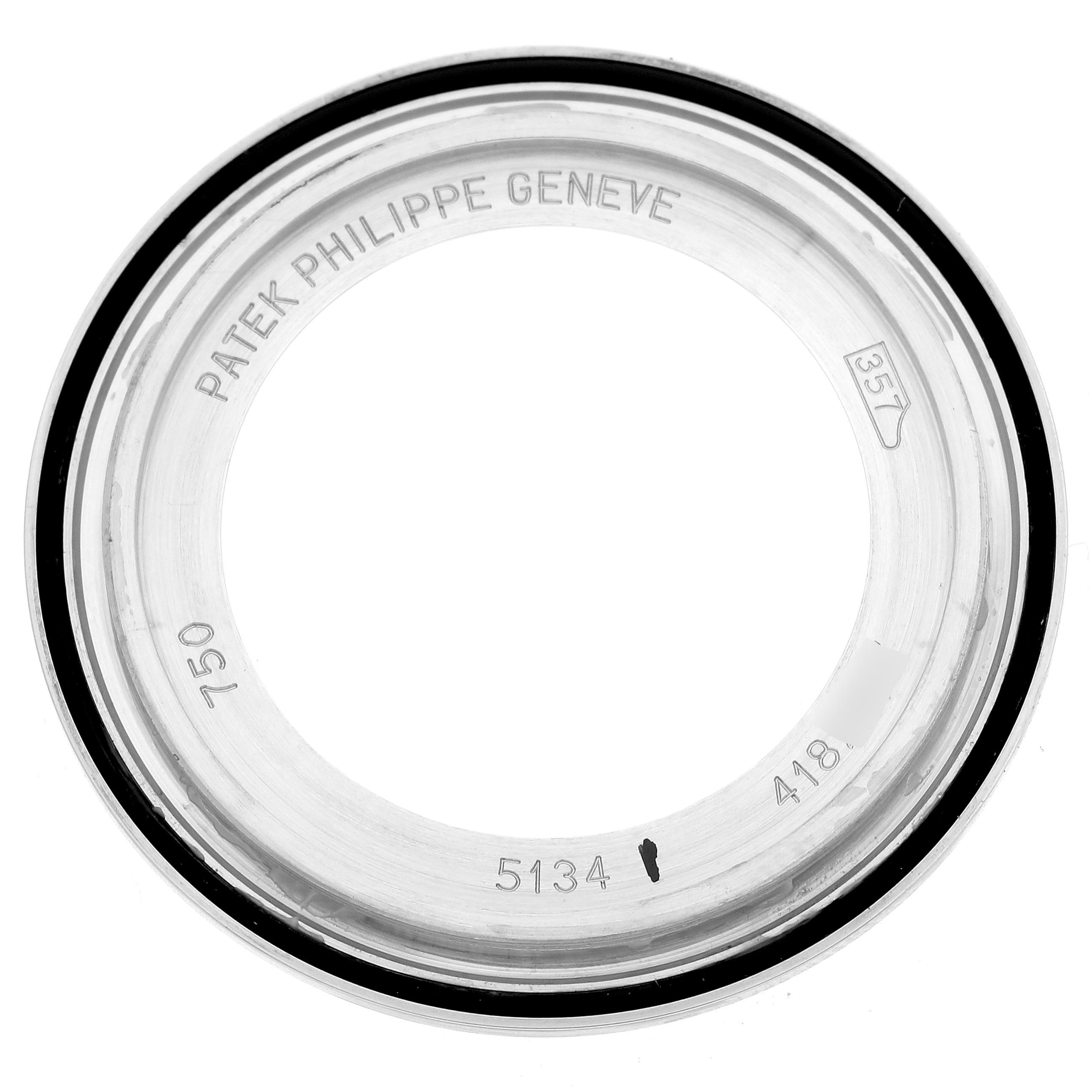 The image shows a top-down view of the bezel or case back ring for a Patek Philippe Calatrava 5134G Men
s White Gold White Dial 5134G Men
s White Gold White Dial watch, displaying engravings.