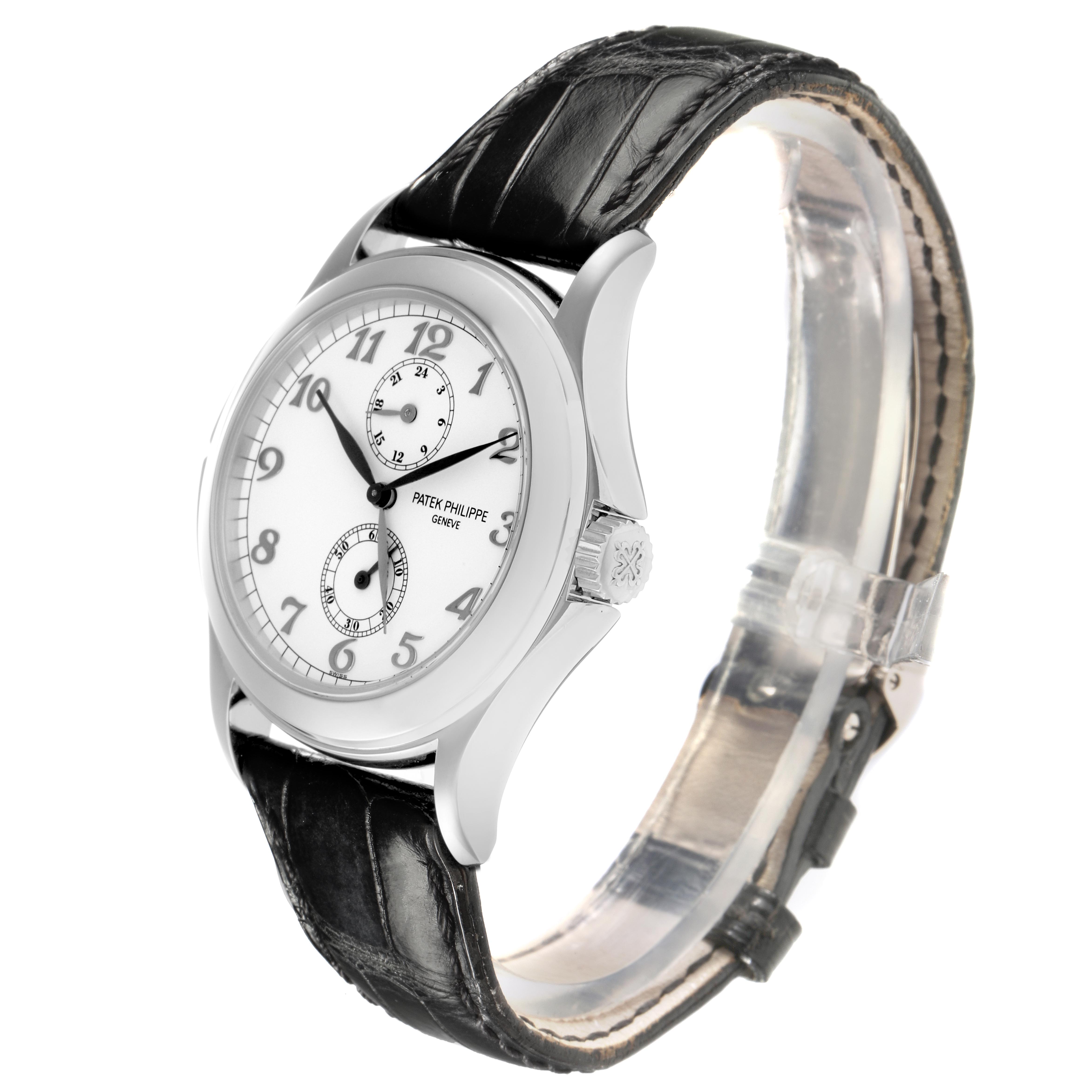 The Calatrava by Patek Philippe is shown from a side angle, highlighting the dial, crown, and black leather strap.