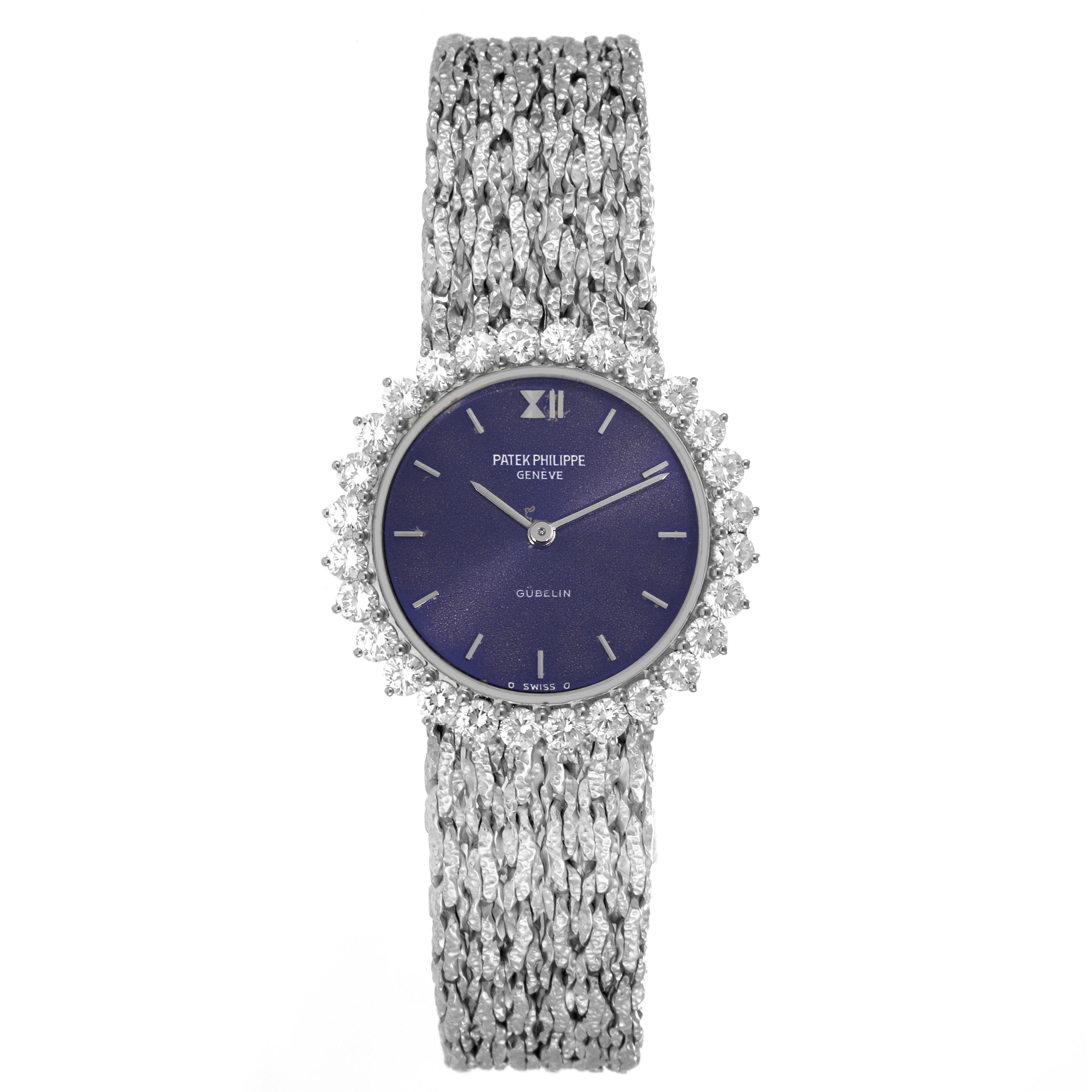 The Patek Philippe Calatrava 4136/001 Women
s White Gold Blue Dial 4136/001 Women
s White Gold Blue Dial watch is shown from a top view, highlighting its textured bracelet and diamond-accented bezel.
