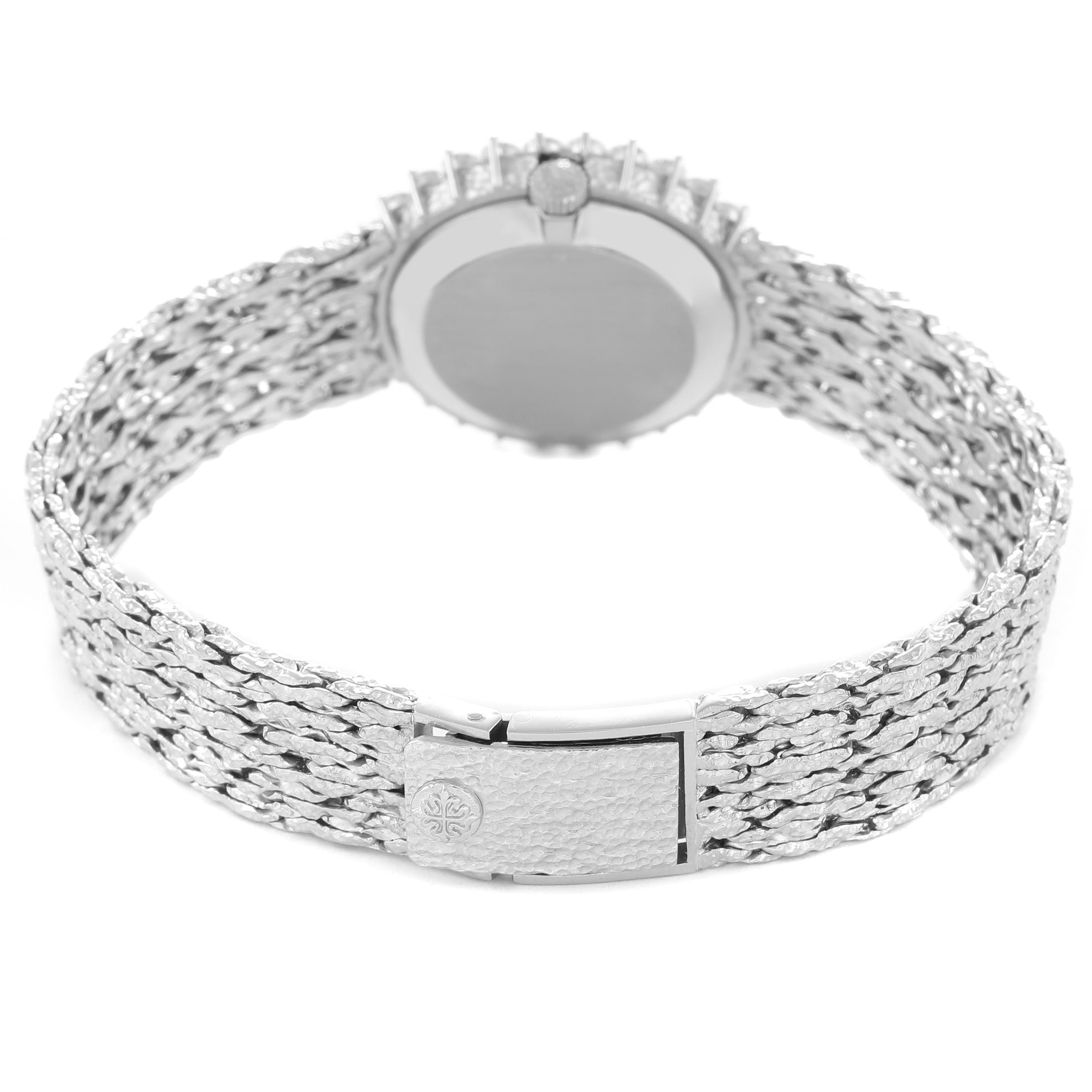 The image shows the Patek Philippe Calatrava 4136/001 Women
s White Gold Blue Dial 4136/001 Women
s White Gold Blue Dial watch from the rear, highlighting its clasp, textured bracelet, and back case.