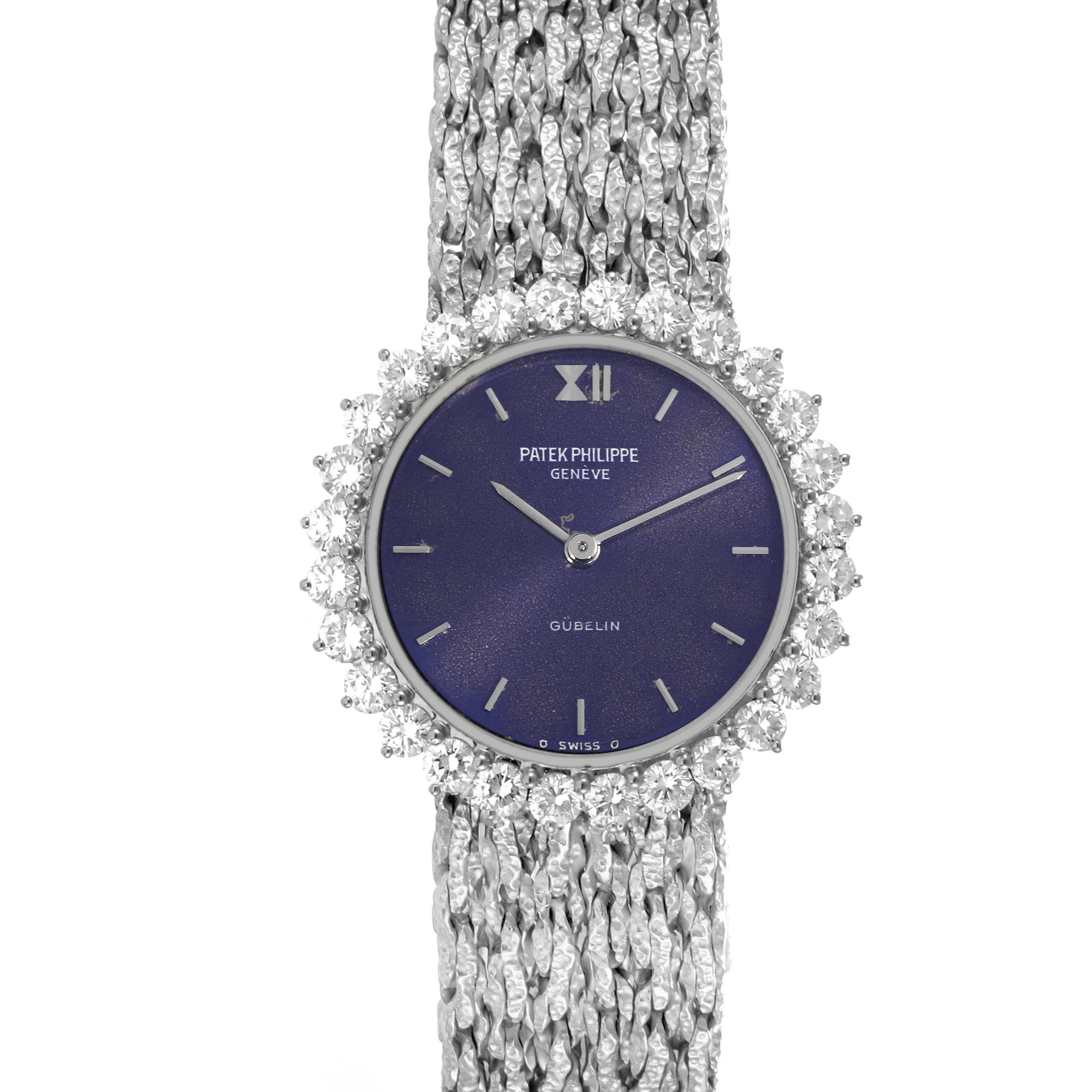 The Patek Philippe Calatrava 4136/001 Women
s White Gold Blue Dial 4136/001 Women
s White Gold Blue Dial watch is shown from a top-down angle, featuring the face, bezel with diamonds, and textured bracelet.