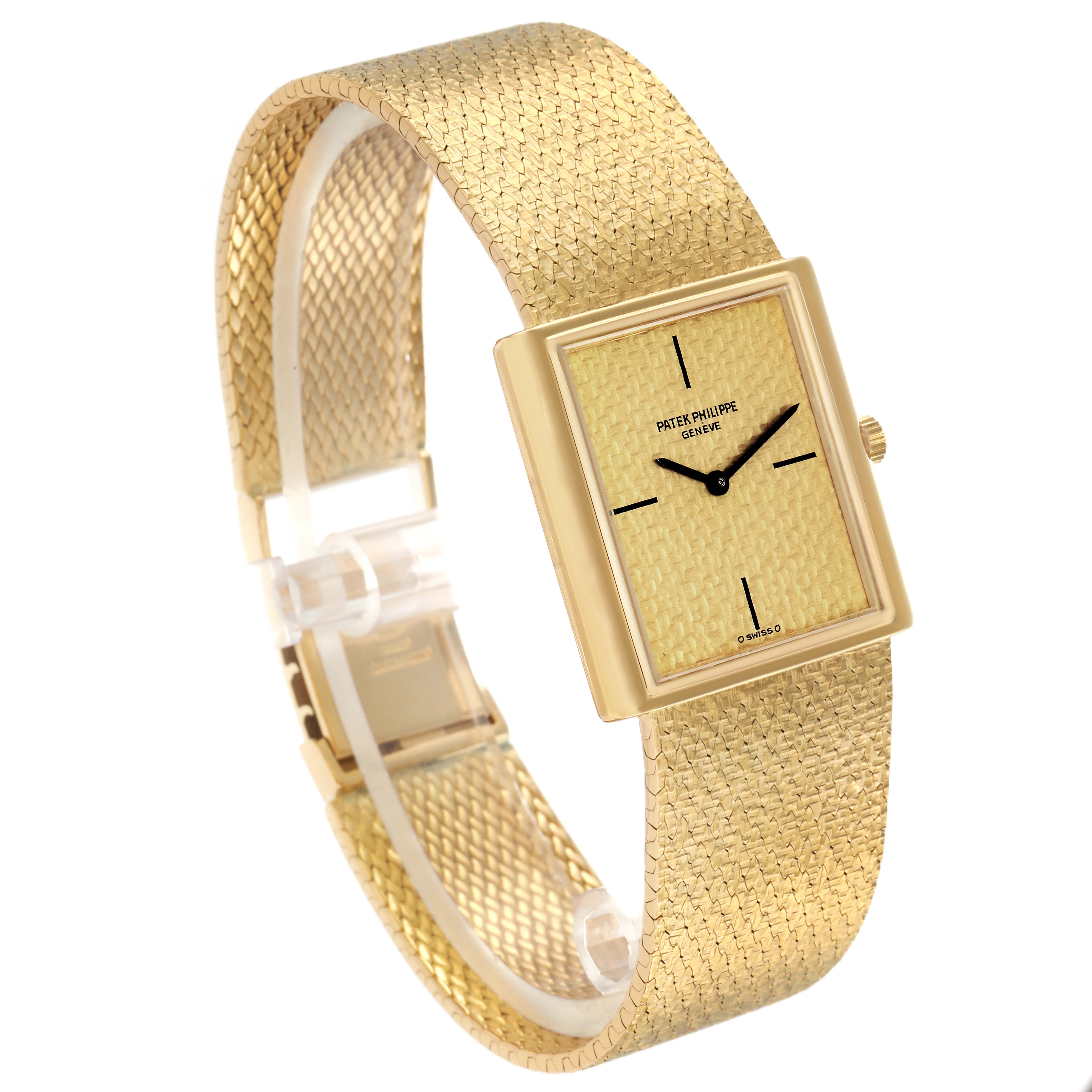 The Vintage Patek Philippe watch is shown at a slight angle, displaying its textured dial, gold case, and woven bracelet.