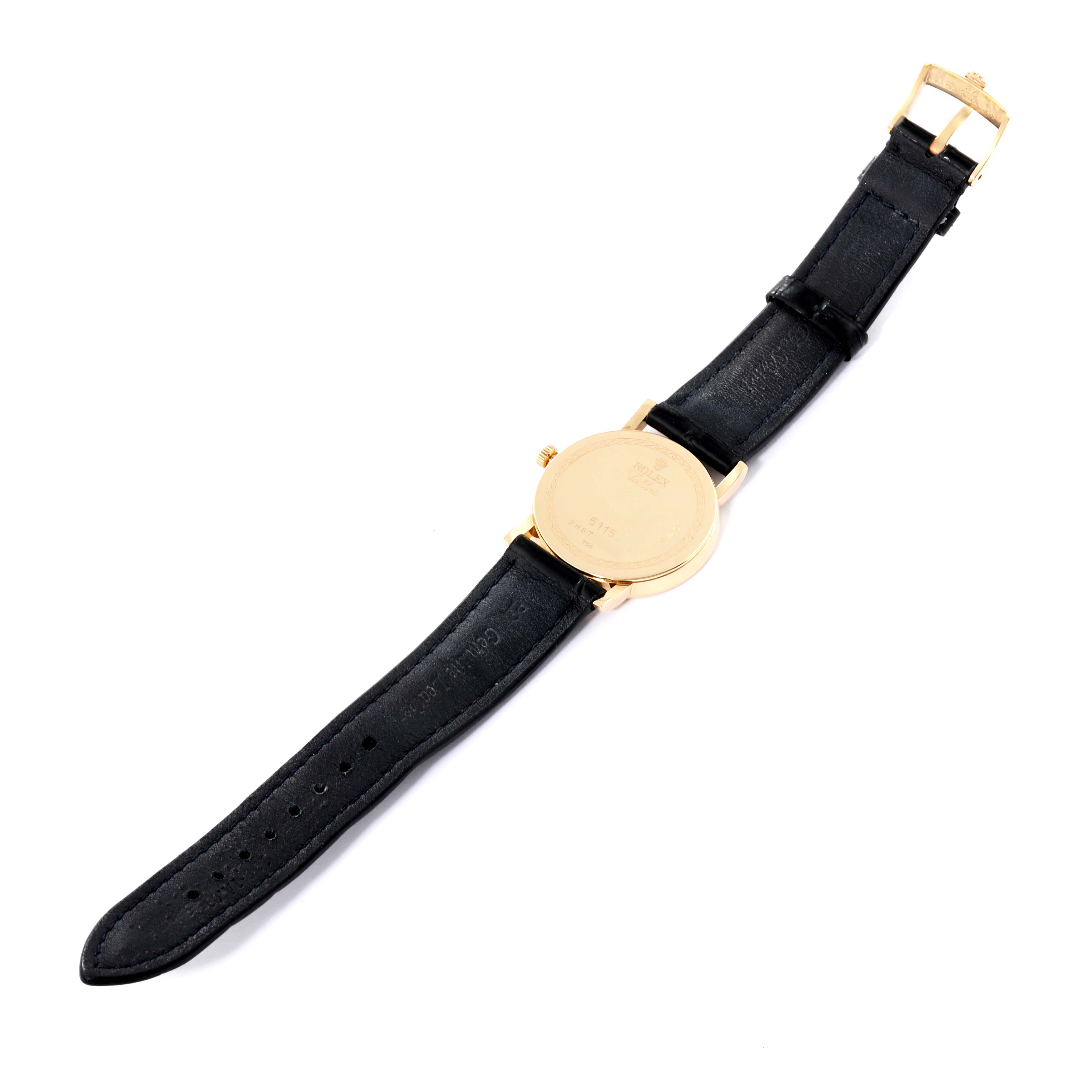 This image shows the back view of a Rolex Cellini 5115/8 Men's Yellow Gold White Dial 5115/8 Men's Yellow Gold White Dial watch featuring a black leather strap and a gold case.