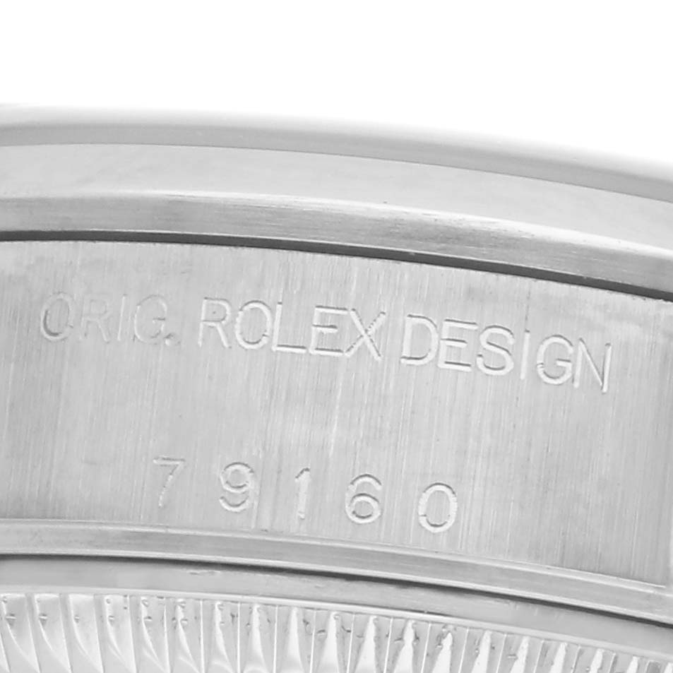 The image shows a close-up of the Rolex Date 79160 Women
s Stainless Steel Pink Dial 79160 Women
s Stainless Steel Pink Dial model bezel with engraved "ORIG. ROLEX DESIGN" and the model number.