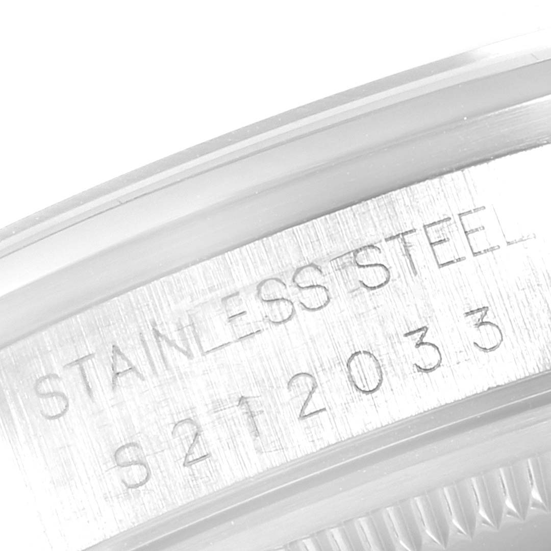 The image shows a close-up of the side of the case of a Rolex Date 15200 Men's Stainless Steel Blue Dial 15200 Men's Stainless Steel Blue Dial model watch, highlighting the "STAINLESS STEEL" engraving.