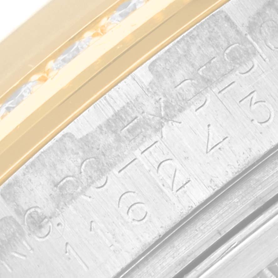 This image shows a close-up of the case side and fluted bezel of a Rolex Datejust 116243 Men's Steel and Gold (two tone) Champagne Dial 116243 Men's Steel and Gold (two tone) Champagne Dial watch with part of the serial number visible.