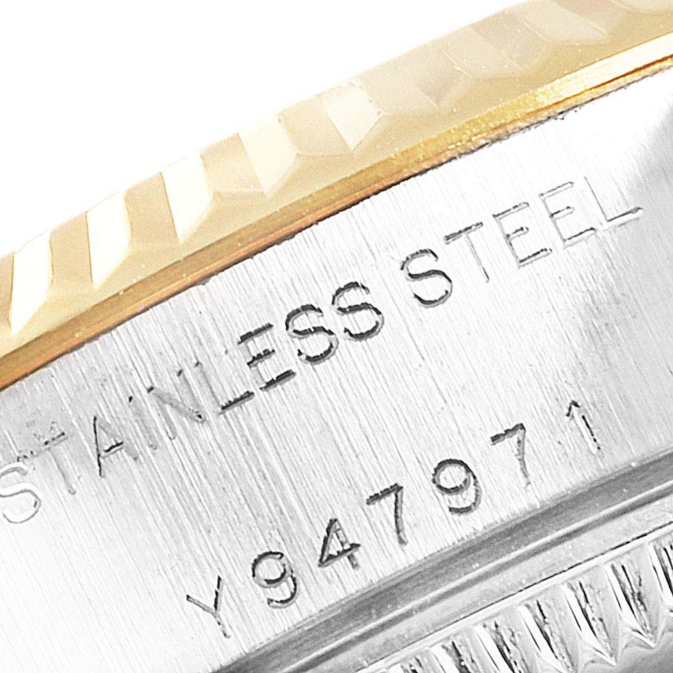 The image shows a close-up of the stainless steel case edge and part of the fluted bezel of a Rolex Datejust 79173 Women
s Steel and Gold (two tone) Champagne Dial 79173 Women
s Steel and Gold (two tone) Champagne Dial watch.