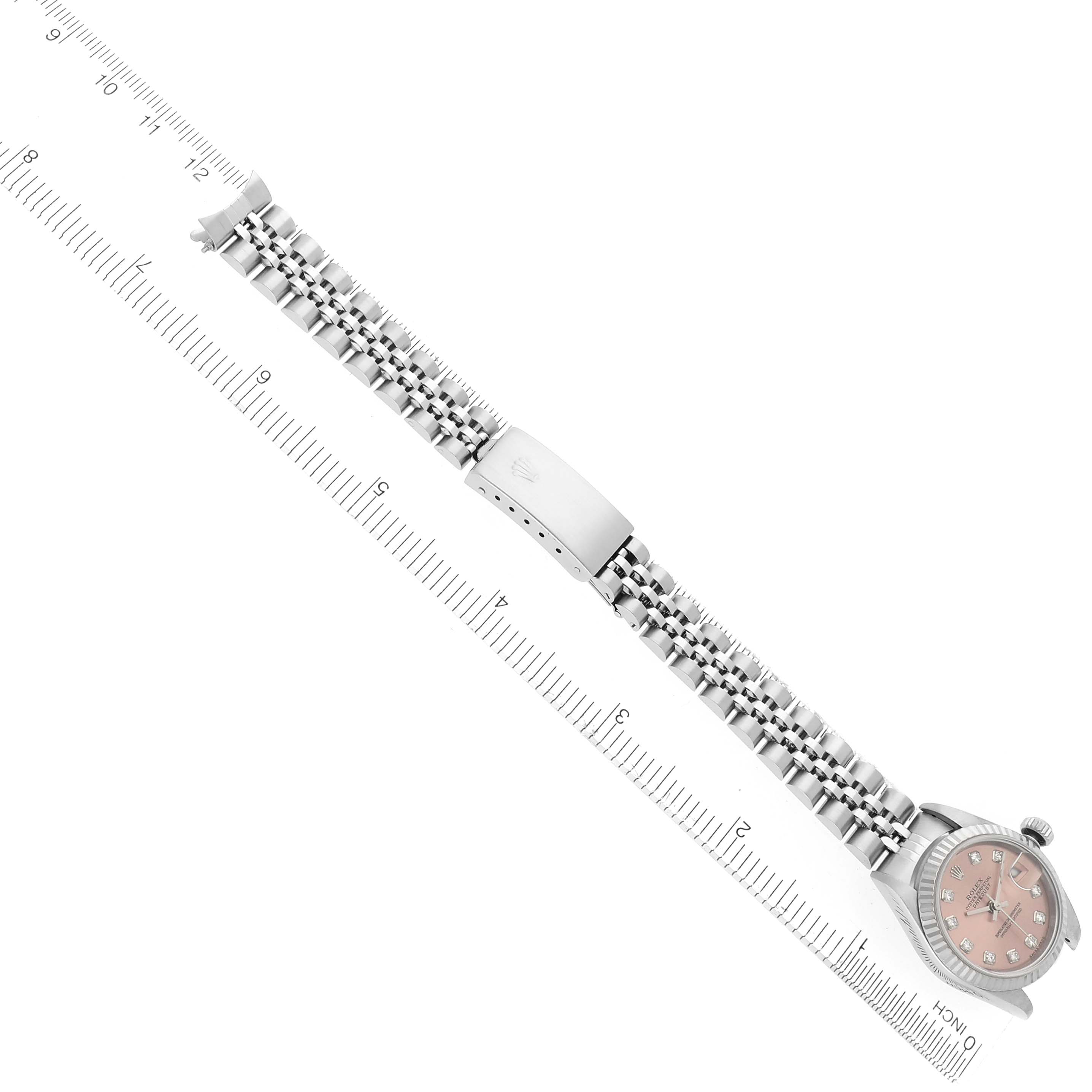 The Rolex Datejust 79174 Women
s Stainless Steel Pink Dial 79174 Women
s Stainless Steel Pink Dial watch is shown at an angled side view, focusing on the bracelet and clasp, with a ruler for scale.