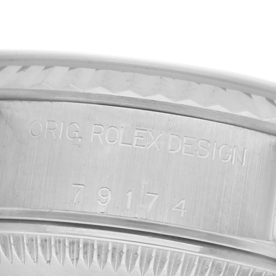 The image shows a close-up of the engraved side of the bezel on a Rolex Datejust 79174 Women
s Stainless Steel Pink Dial 79174 Women
s Stainless Steel Pink Dial watch.