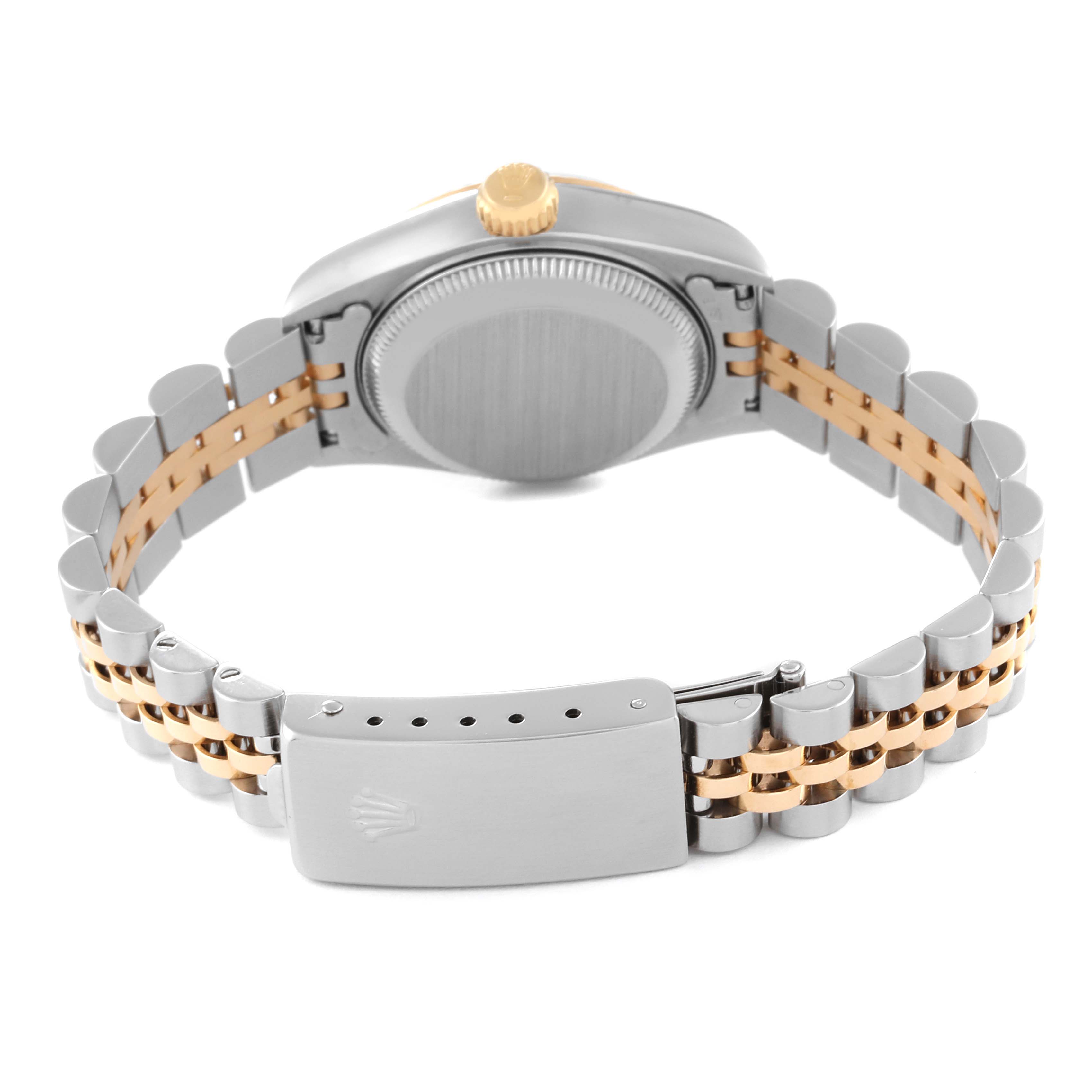 The image shows the back view of a Datejust Rolex watch, focusing on its two-tone bracelet and clasp.
