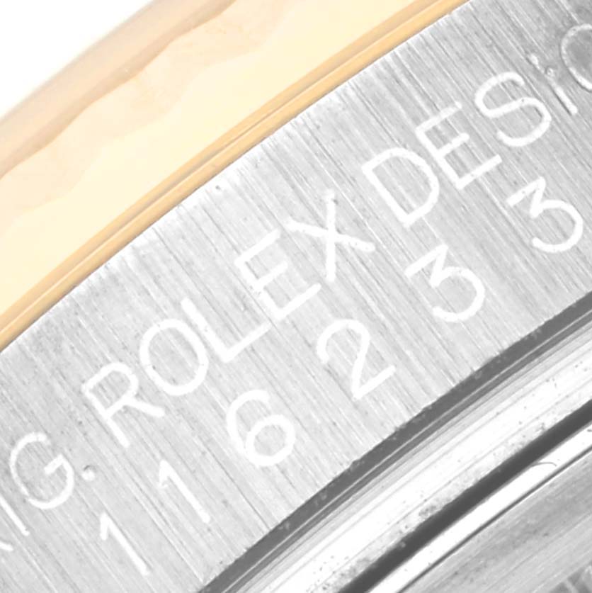 This image shows a close-up of the side engraving on the case of a Rolex Datejust 116233 Men's Steel and Gold (two tone) Champagne Dial 116233 Men's Steel and Gold (two tone) Champagne Dial watch.