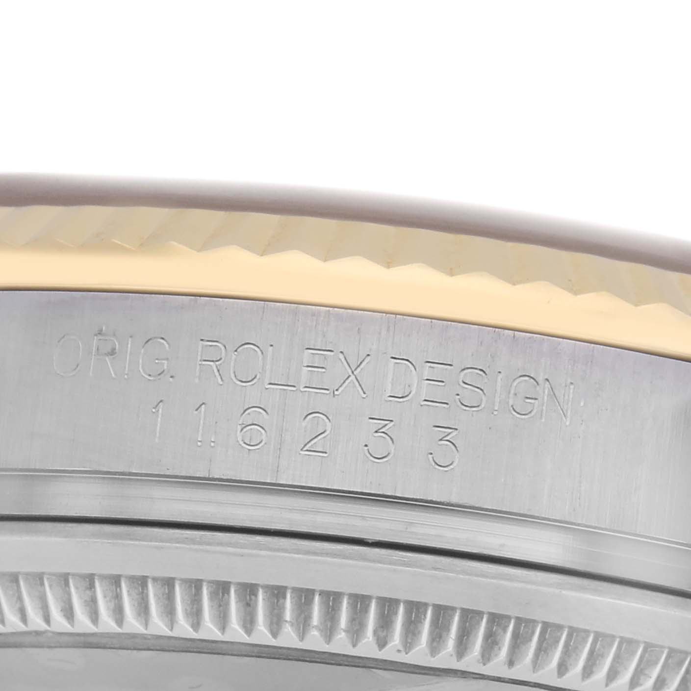 This image shows the side engraving and edge of the bezel of a Rolex Datejust 116233 Men
s Steel and Gold (two tone) Champagne Dial 116233 Men
s Steel and Gold (two tone) Champagne Dial watch.